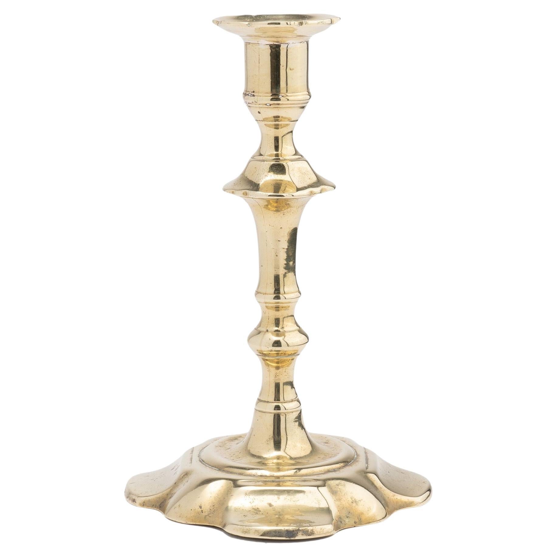 English Queen Anne cast brass petal base candlestick, 1750-60