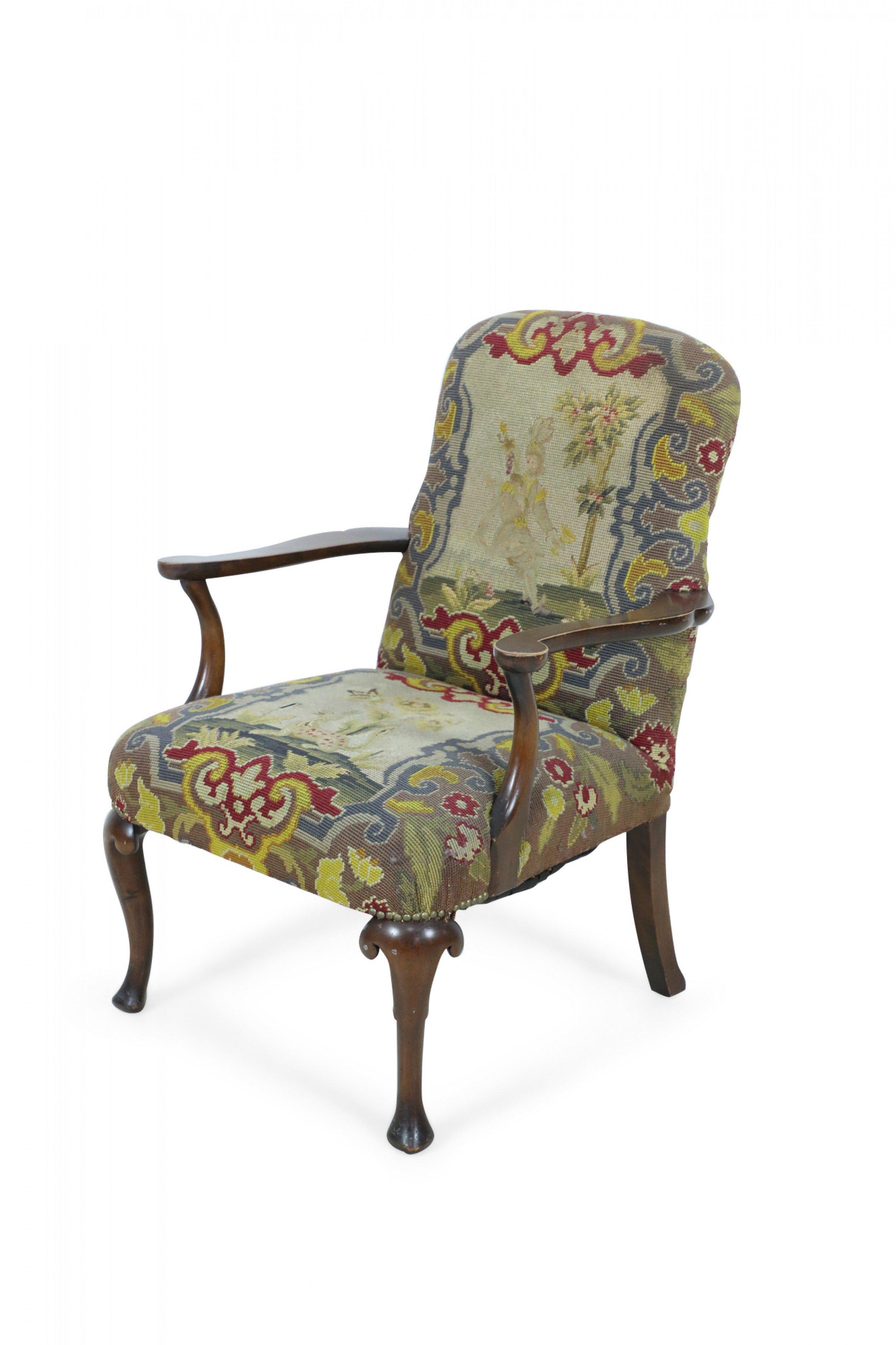 English Queen Anne (18th century) armchair with green, beige, and red needlepoint tapestry upholstered seat and back with a walnut frame having two scroll arms and cabriole legs.