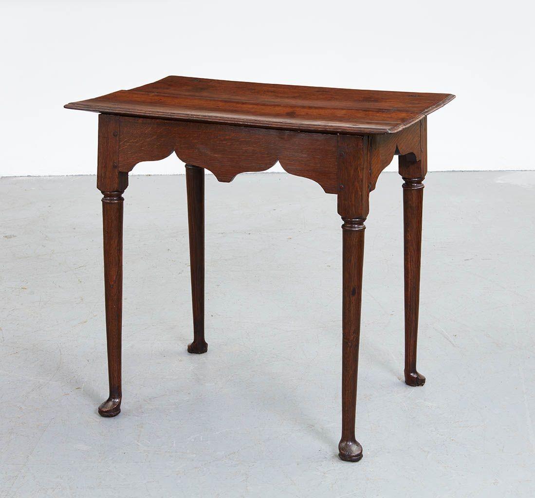 An early 18th century English oak center table with rectangular two plank top with molded edge over 
