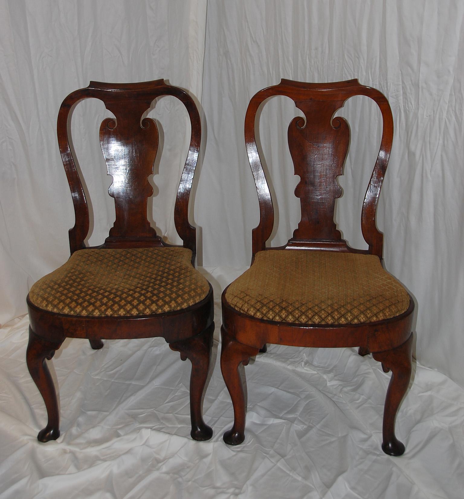 English Queen Anne period walnut pair of balloon seated sidechairs with cabriole legs, pad feet and lovely curved and waisted back. The upholstery is about 10 years old, as is a repair to one back leg which had to be spliced about 5