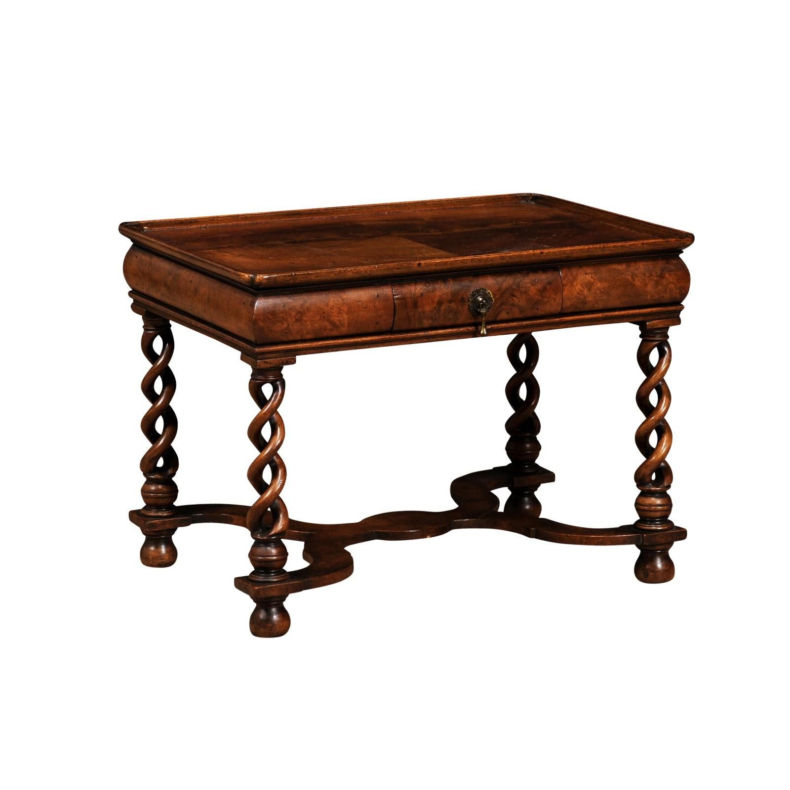 An English Queen Anne style burl walnut coffee table from circa 1910 with bookmatched tray top, carved twisted legs and X-Form cross stretcher. This English Queen Anne style coffee table, dating back to circa 1910, is a marvelous representation of