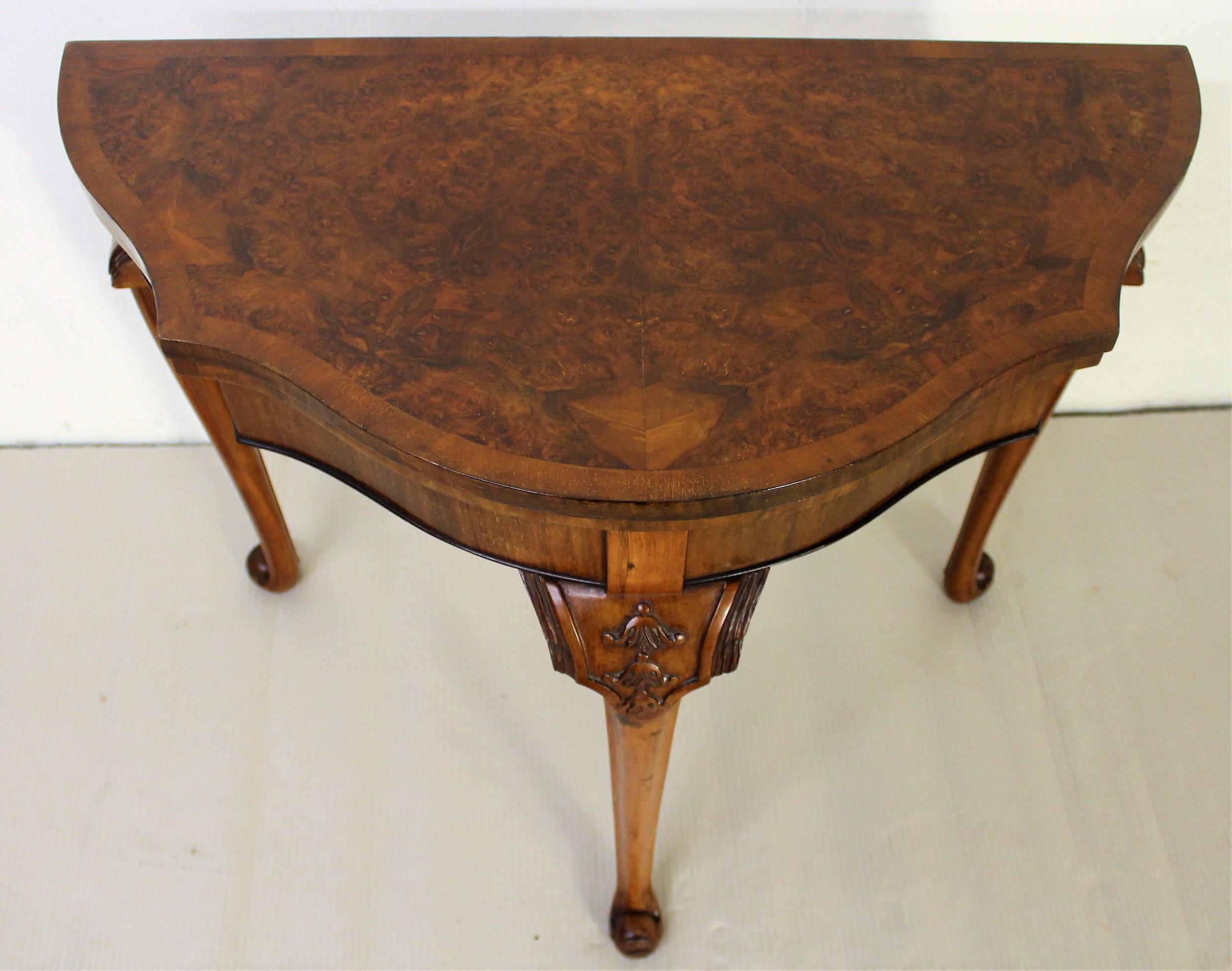 A charming burr walnut card/games table in the Queen Anne style. Well made in solid walnut with attractive burr walnut veneers. Of serpentine form with a crossbanded top. The top opens to reveal a playing surface fitted with a green baize. Whilst in