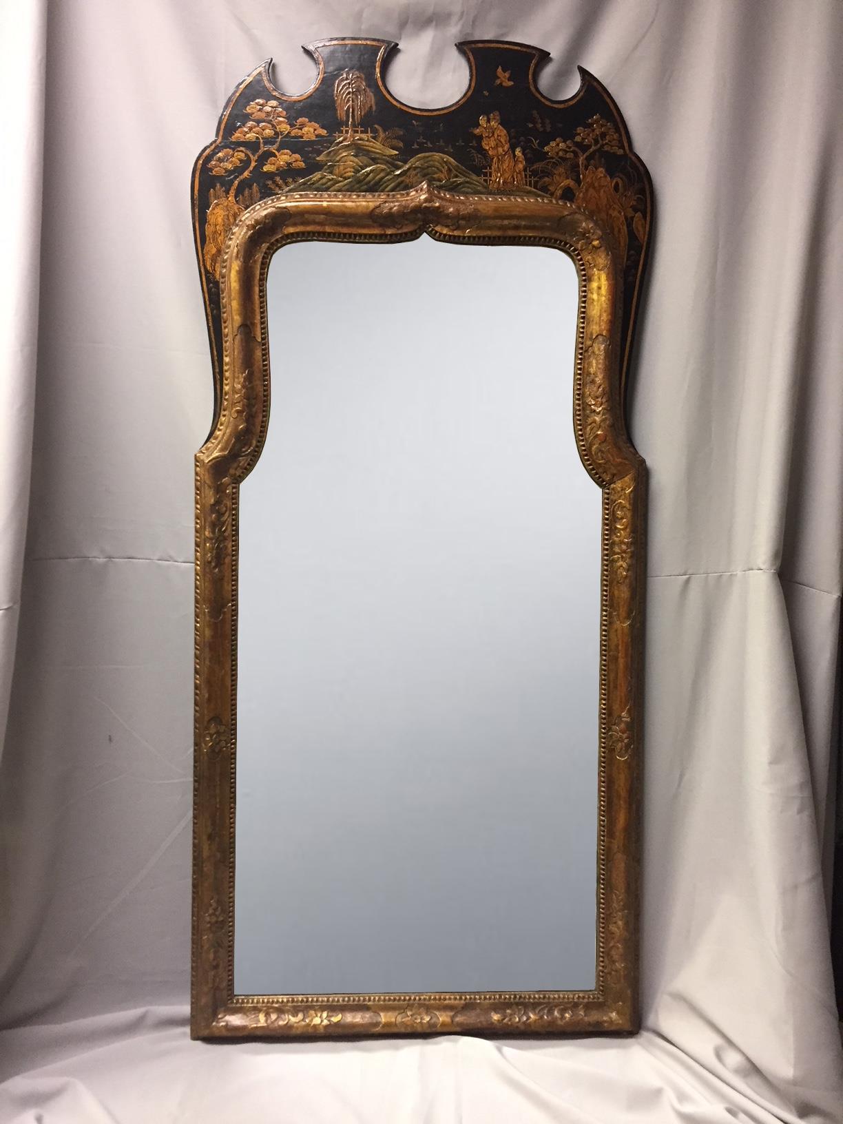 Beautiful and large 19th century English Queen Anne style japanned mirror. Lacquered and gilt decorated uniquely shaped surmount depicting an Asian family in a garden over mirror plate within an attractive carved giltwood frame.
Possibly 18th