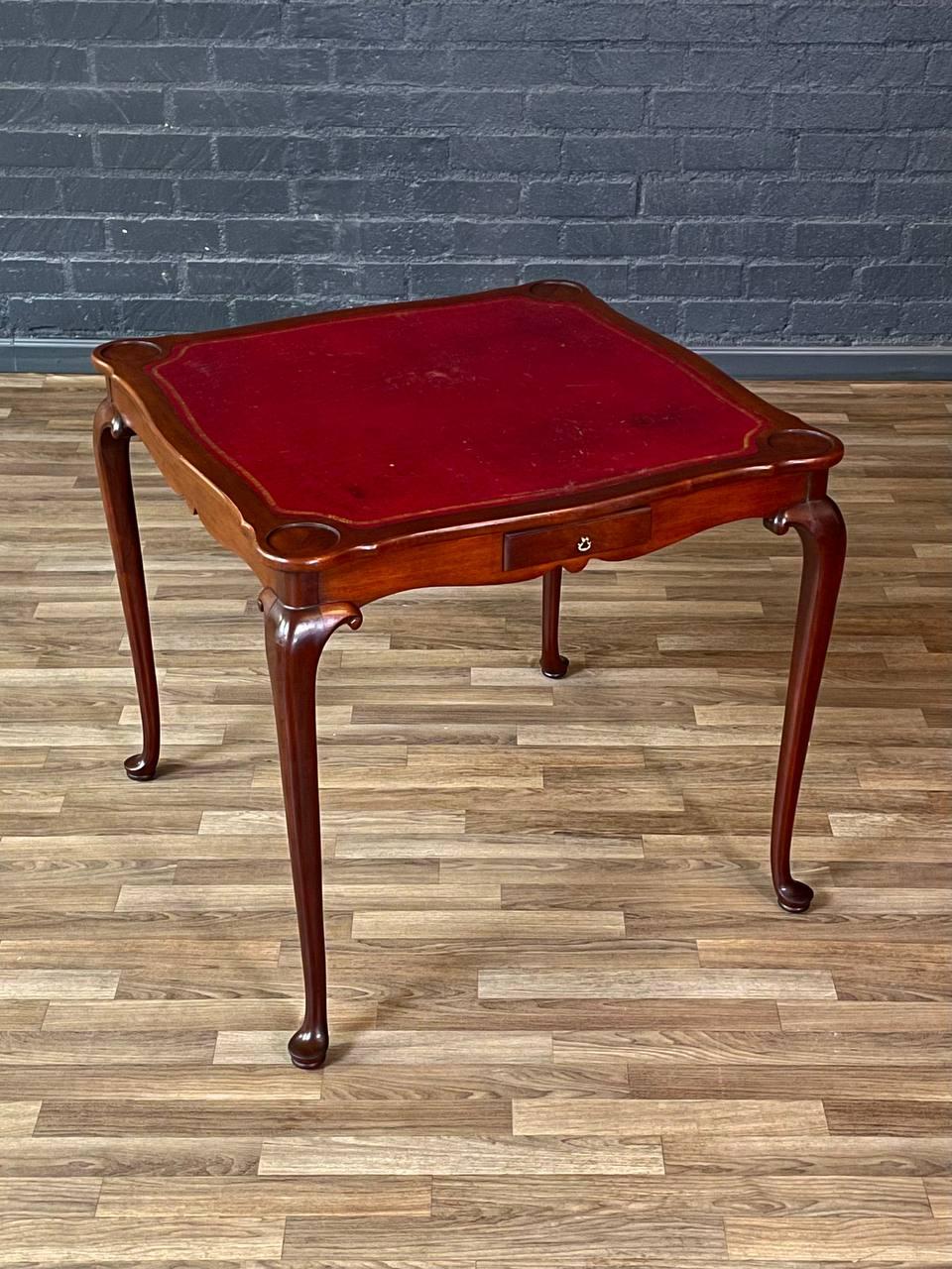 Condition: Original Vintage Condition
Designer: The Williamsburg Galleries 
Manufacturer: The Williamsburg Galleries  
Materials: Mahogany, Red Gilt-Tooled Leather, Brass Pull

This English Queen Anne style card and game table by The Williamsburg