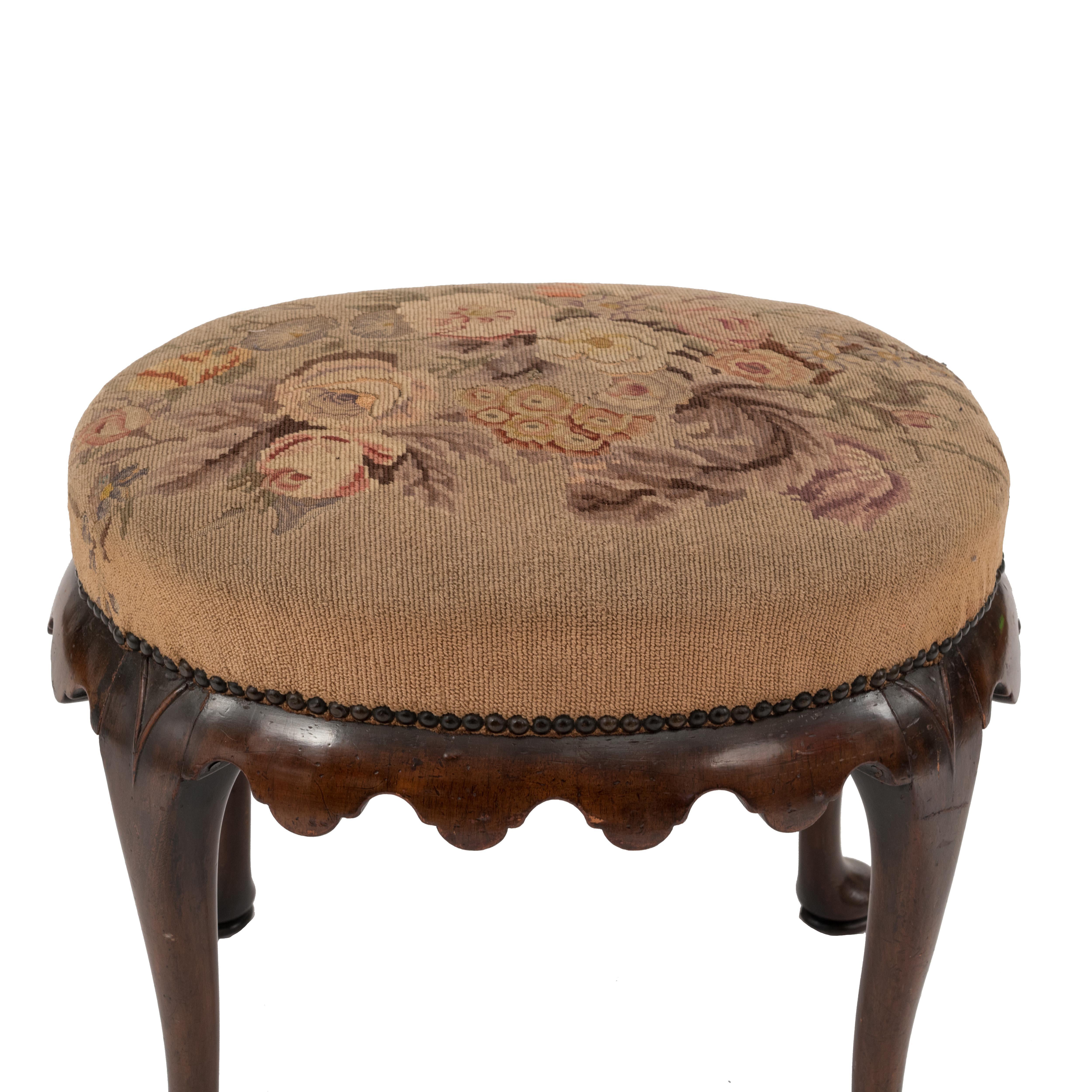 English Queen Anne style (19th century) oval walnut bench with scalloped apron and needlepoint seat.
      