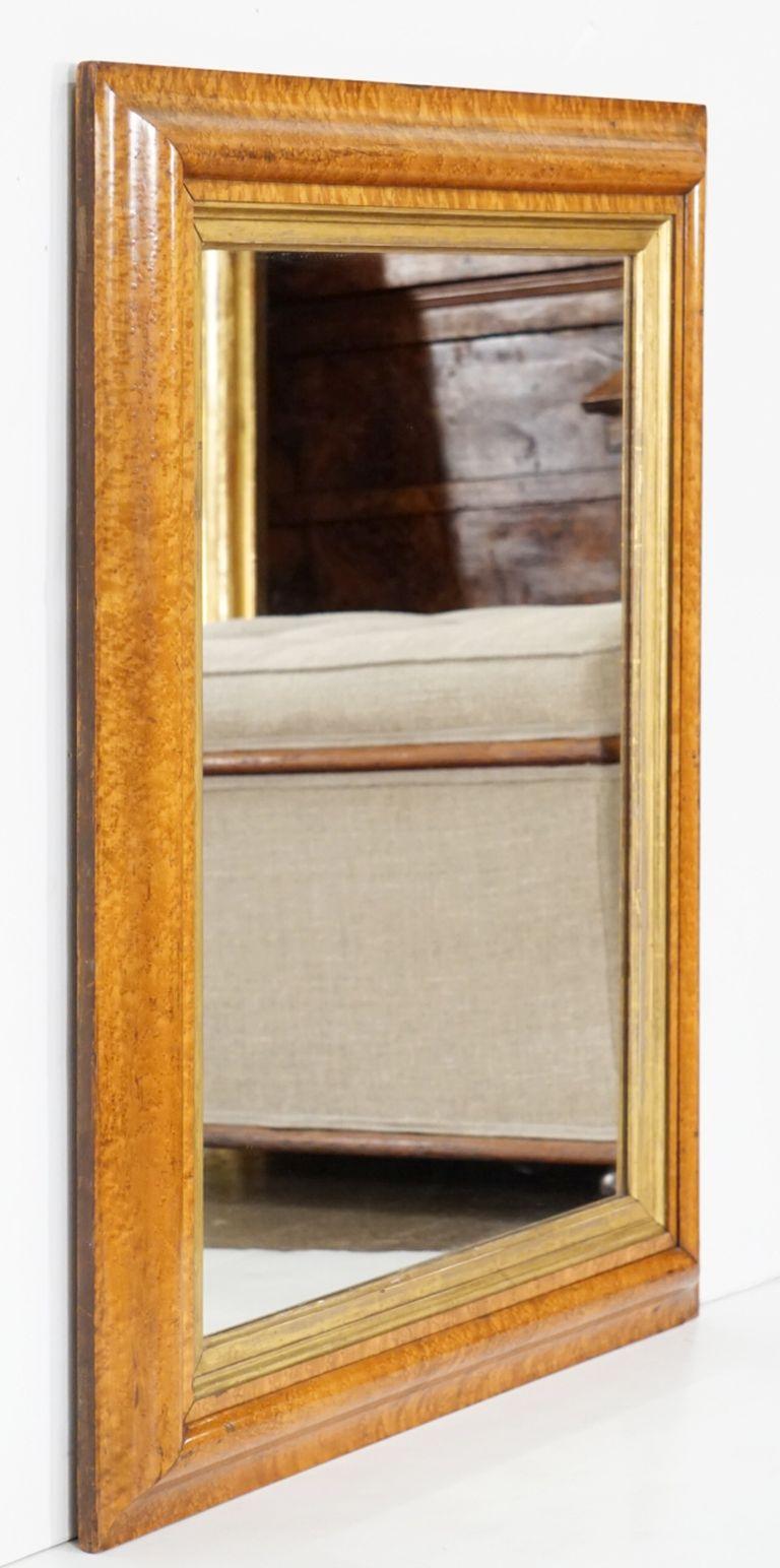 A fine English rectangular mirror featuring a bird’s-eye or curly maple frame with a giltwood 'slip' around the inner moulding.

Ready for display - vertically or horizontally.

Dimensions: Height 34 1/2 inches x Width 29 3/4 inches x Depth 1 3/4