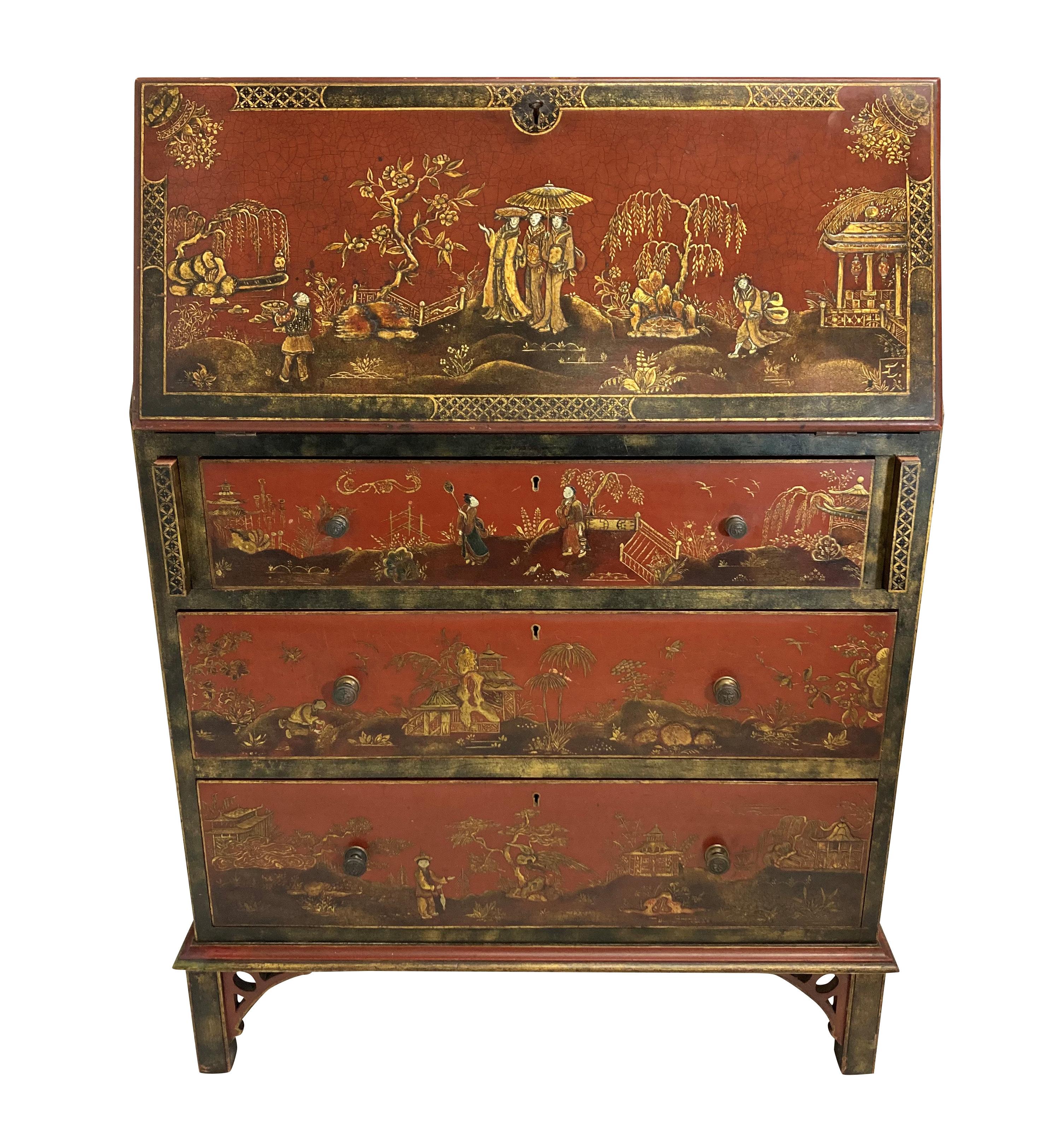 An English red Japanned bureau, comprising three drawers, with an upper fall front desk with a mahogany interior and a leather top.