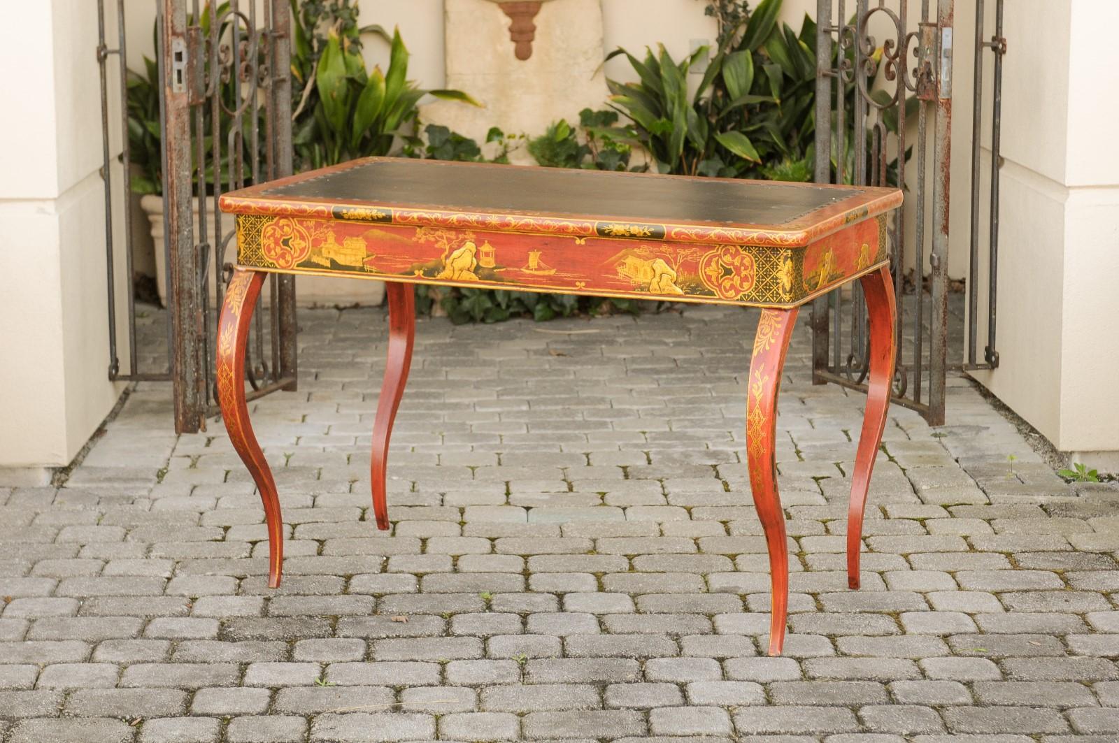 An English Regency period writing table from the early 19th century, with red lacquered, black and gilt chinoiserie decor and cabriole legs. Born in England in the early years of the Regency era, this exquisite table features a rectangular top with