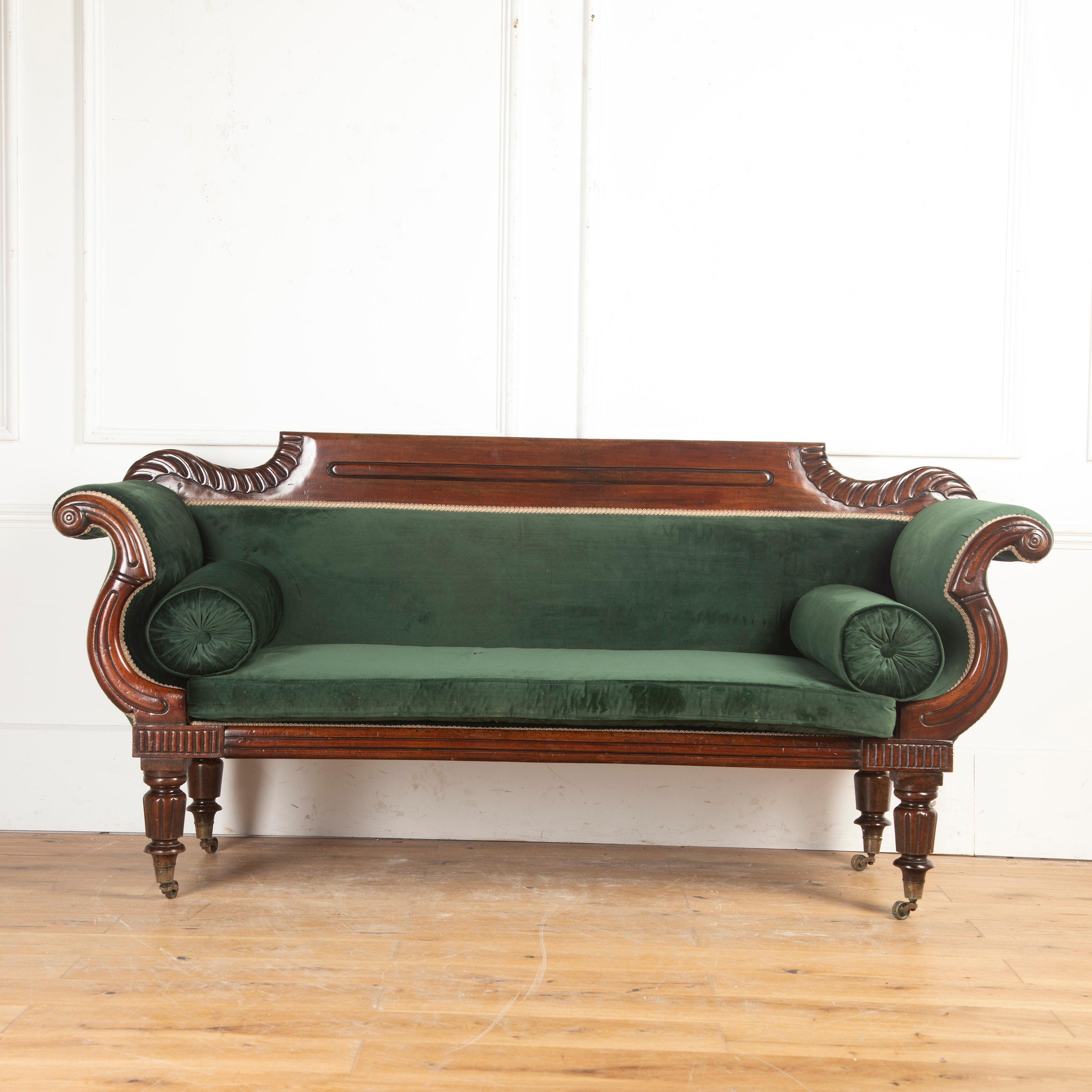 English early 19th century Regency mahogany sofa.

This gorgeous country house sofa features a deeply carved mahogany frame with a deep aged patina.

The flat-arched top rail is flanked on either side by bold gadrooning behind the beautifully