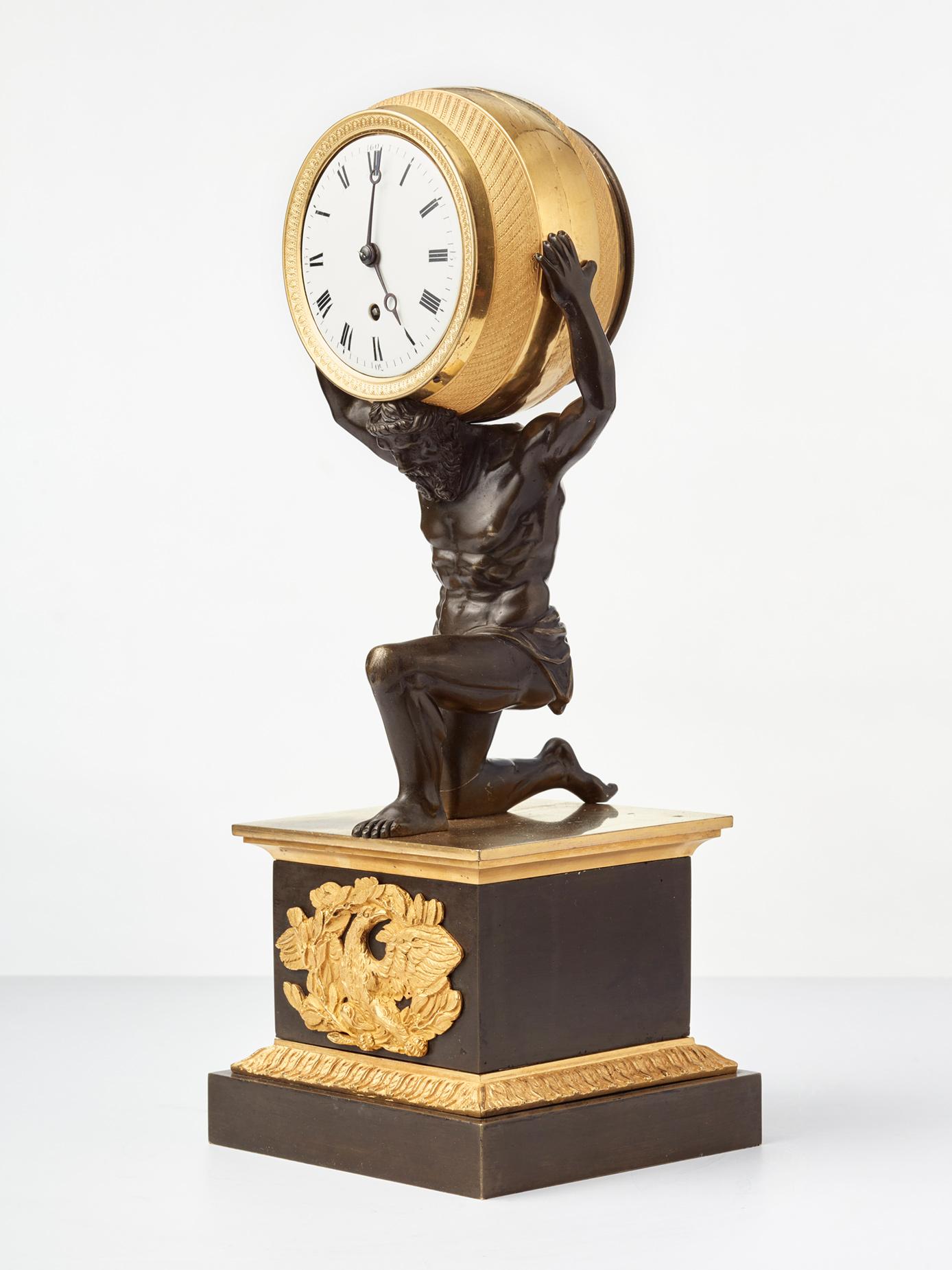 The company F. Baetens of London was a very well known maker of high quality sophisticated clock cases with incredible details. Their clocks were sold to high status titled or royal families. 

The patinated bronze figure of Atlas carries on his