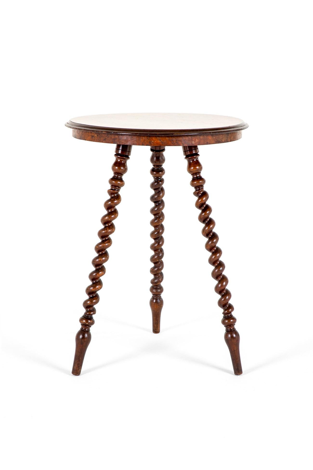 An unusual 19th century walnut topped occasional table.

The table top exhibits exceptional colour and grain with a mahogany banded moulded edge.

The top is raised on three barley twist turned legs and finished on arrow feet. This beautiful