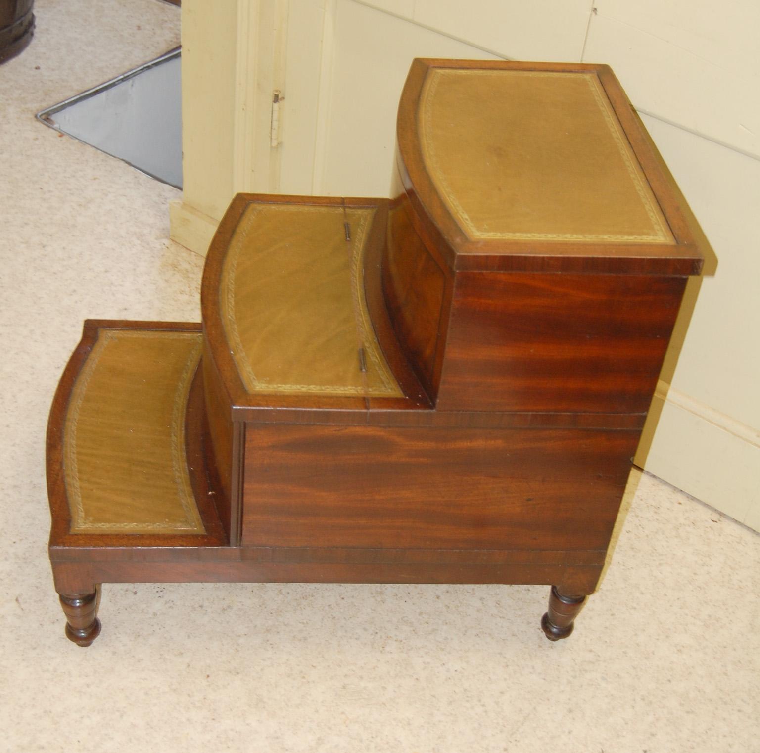 

 English Regency  bowfront mahogany converted bedstep commode.  The central pullout has been converted to a drawer which slides in and out, the tread also hinges up for easy access.  The top step is also hinged, revealing another storage space. 