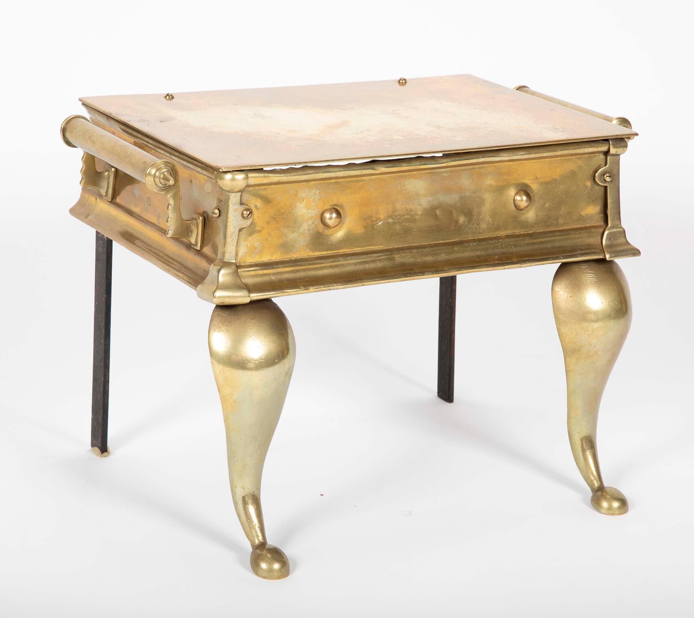 19th century English Regency brass footman, or fireplace trivet, makes a wonderful and unusual drinks or side table. With cabriole legs and handsome detailing on the corners and handles. Circa 1825. 
Measures: 12 inches high 18 wide 12 deep.