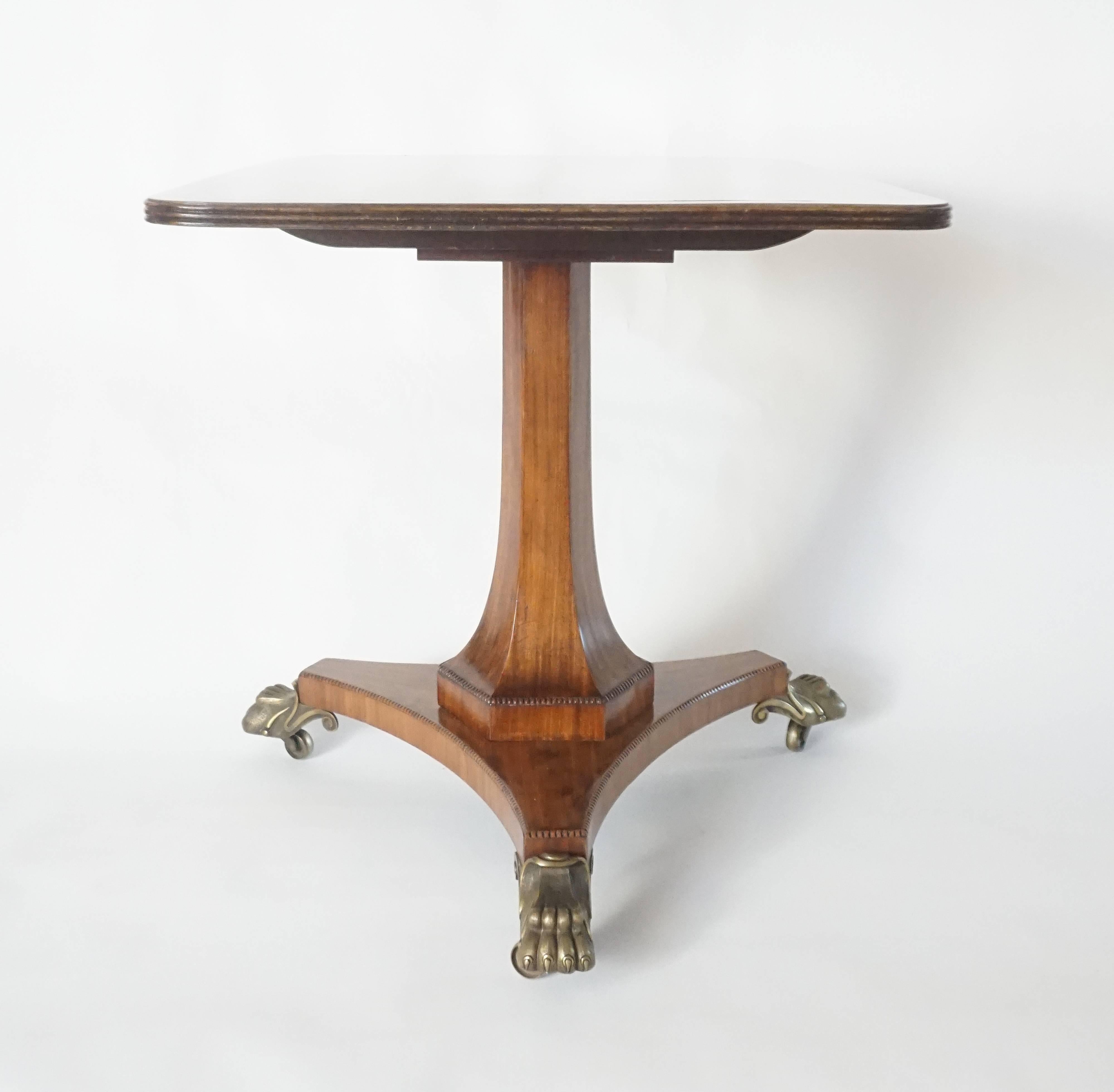 An exceptional, circa 1820 English Regency period mahogany tilt-top table of unusual form having solid single-timber rectangular top with line-inlaid brass border and reeded edge upon reverse-tapering hexagonal-form pedestal support with beaded