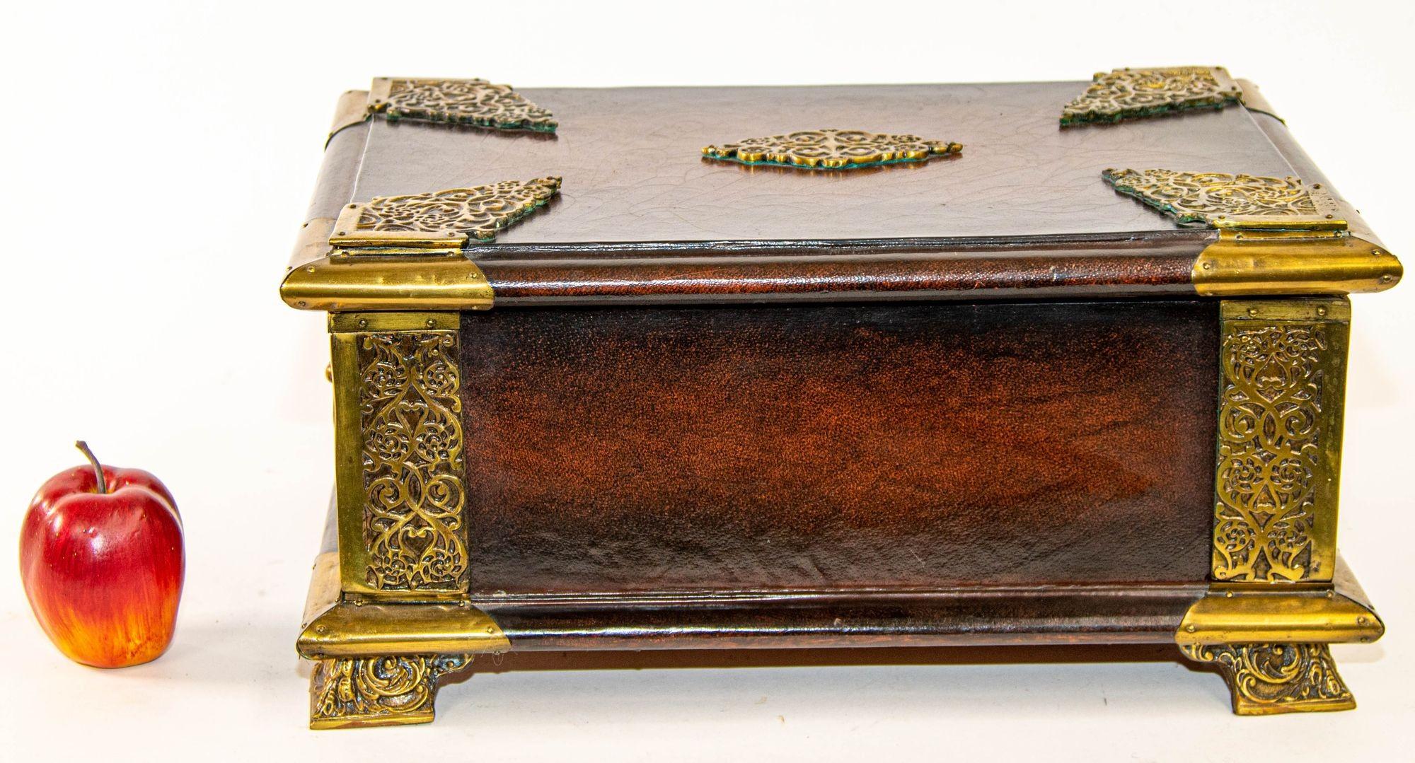 Italian Brown Leather Jewelry Box with Gold Tooling.
Large Italian gilt tooled leather wrapped table box, with domed top gilt decoration, raised on four bronze paw feet.
Vintage leather wrapped trunk with solid brass ornate feet, the top opens to