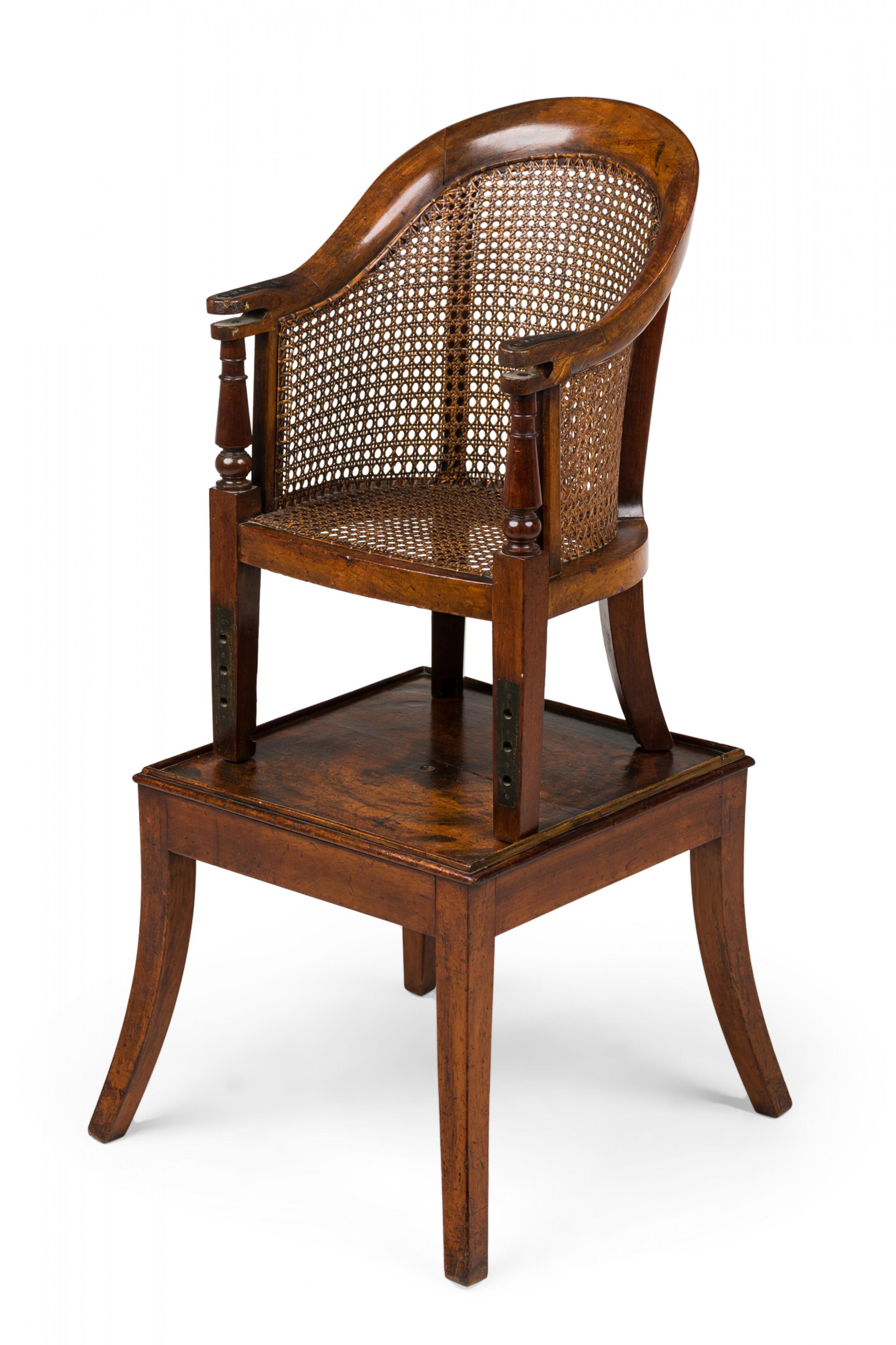 English Regency child's chair featuring a curved crest rail resting on turned supports with open space for a safety bar (not included), and a caned back and seat. The chair's front legs each have four identical holes near the bottom and the back