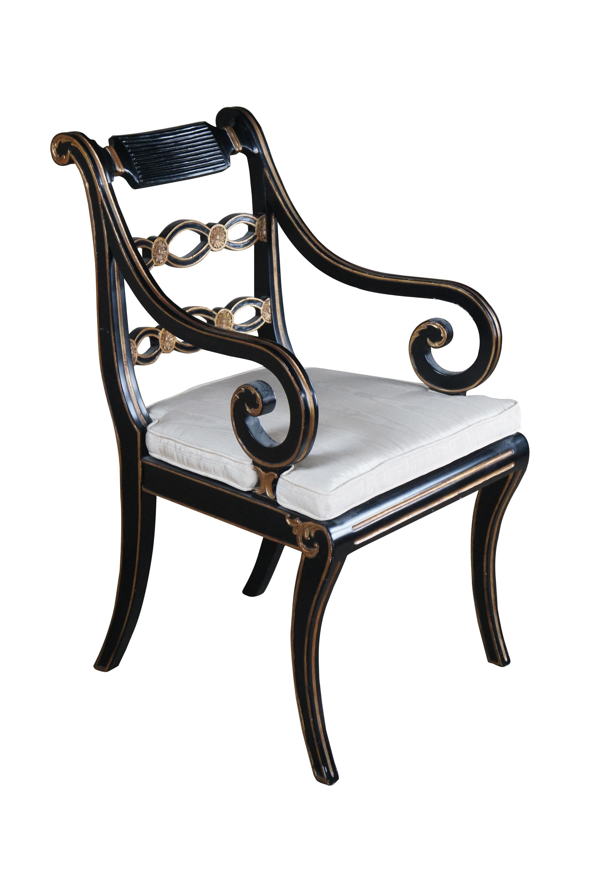 Vintage English Regency style pierced Riddle back armchair featuring ebonized black painted frame with gold accents, caned seat and scrolled arms.

Dimensions:
23.5