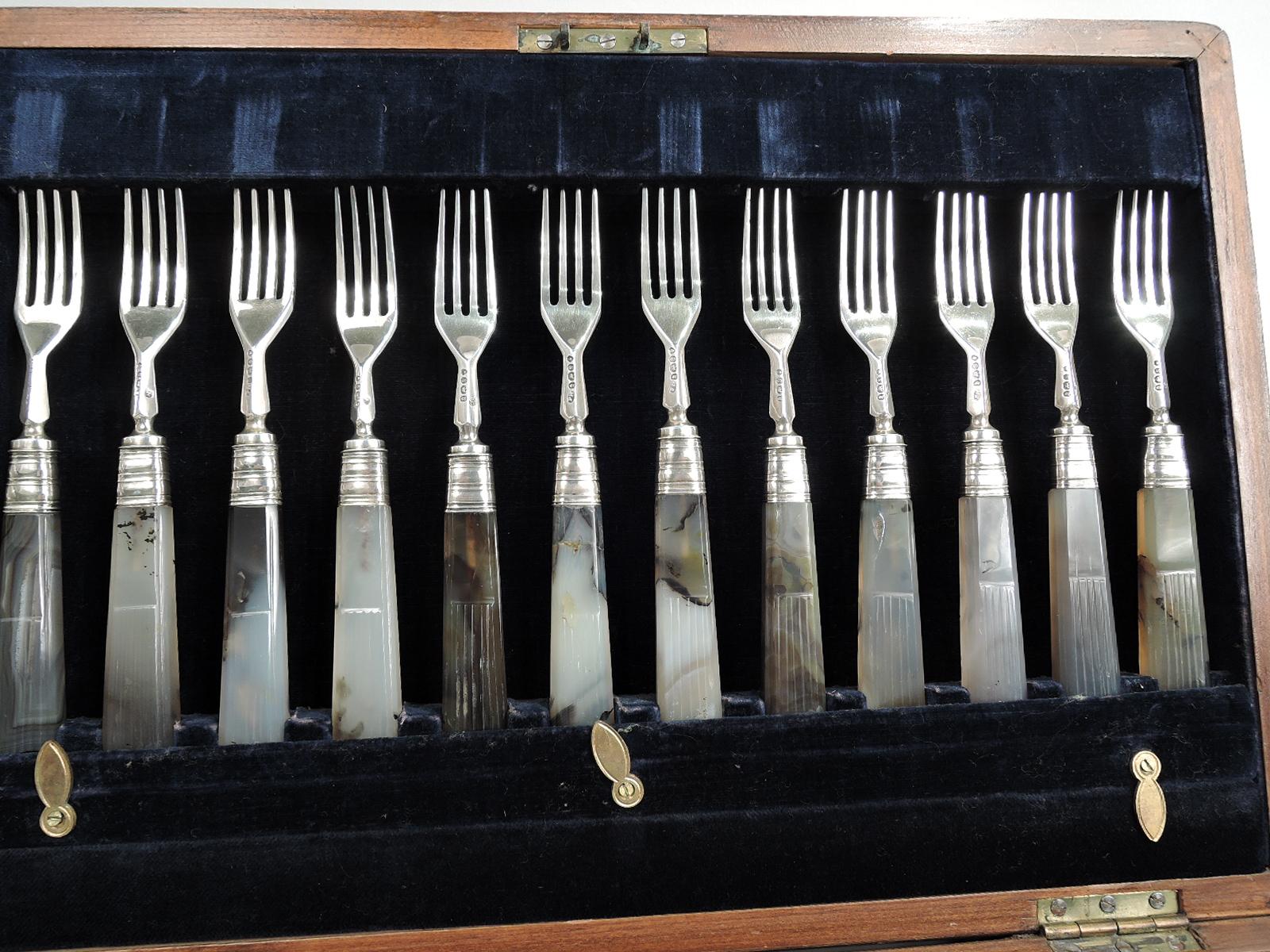 George IV sterling silver and agate fruit set for 12 with 24 pieces. Made by Francis Higgins in London in 1833. This set comprises 12 forks and 12 knives. Tapering rectilinear half-fluted handles in mottled grey and brown agate. Sterling silver