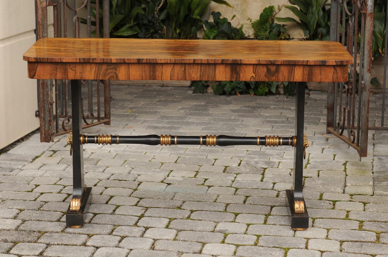 An English Regency rosewood console table from the mid-19th century, with ebonized wood base. Delve into the elegance of the Regency period with this English console table from the mid-19th century, crafted from rosewood with an ebonized wood base.