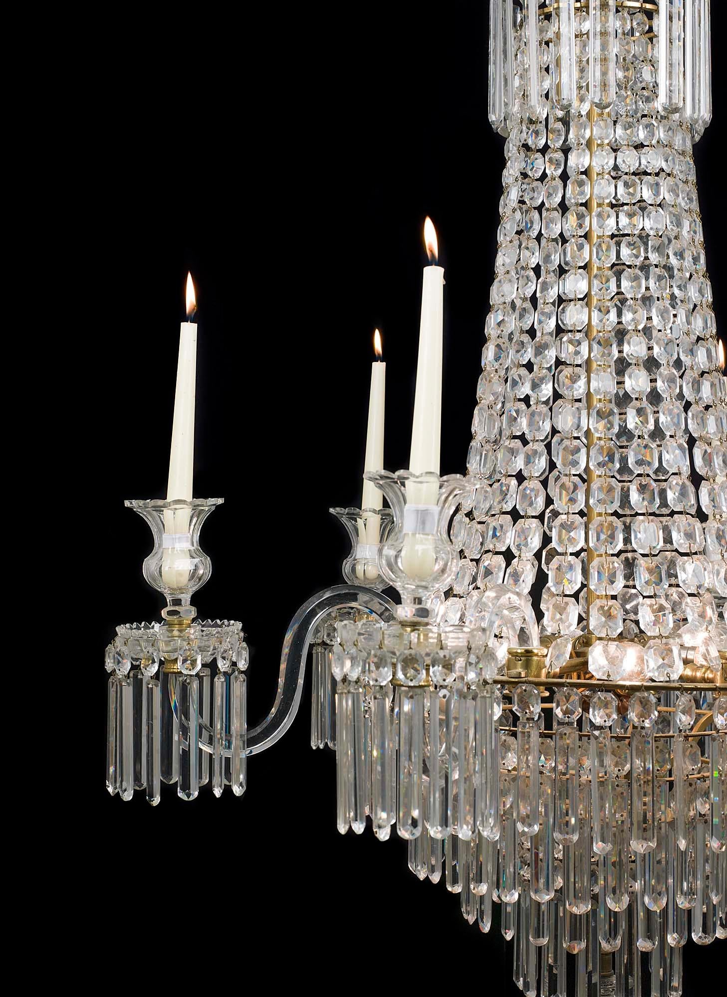 A very fine English Regency six branch crystal waterfall chandelier the four tiers profusely hung with pendant and bead drops, each solid arm with vase shaped candle holders and hung with further bead and pendant drops.
English, 19th Century.

Note: