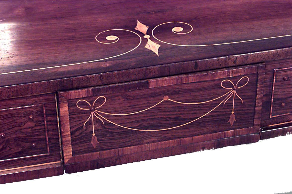 English Regency rosewood and satinwood inlaid double pedestal sideboard with a back rail and large cellarette drawers having brass snake handles. (DUVEEN BROS label in drawer)
