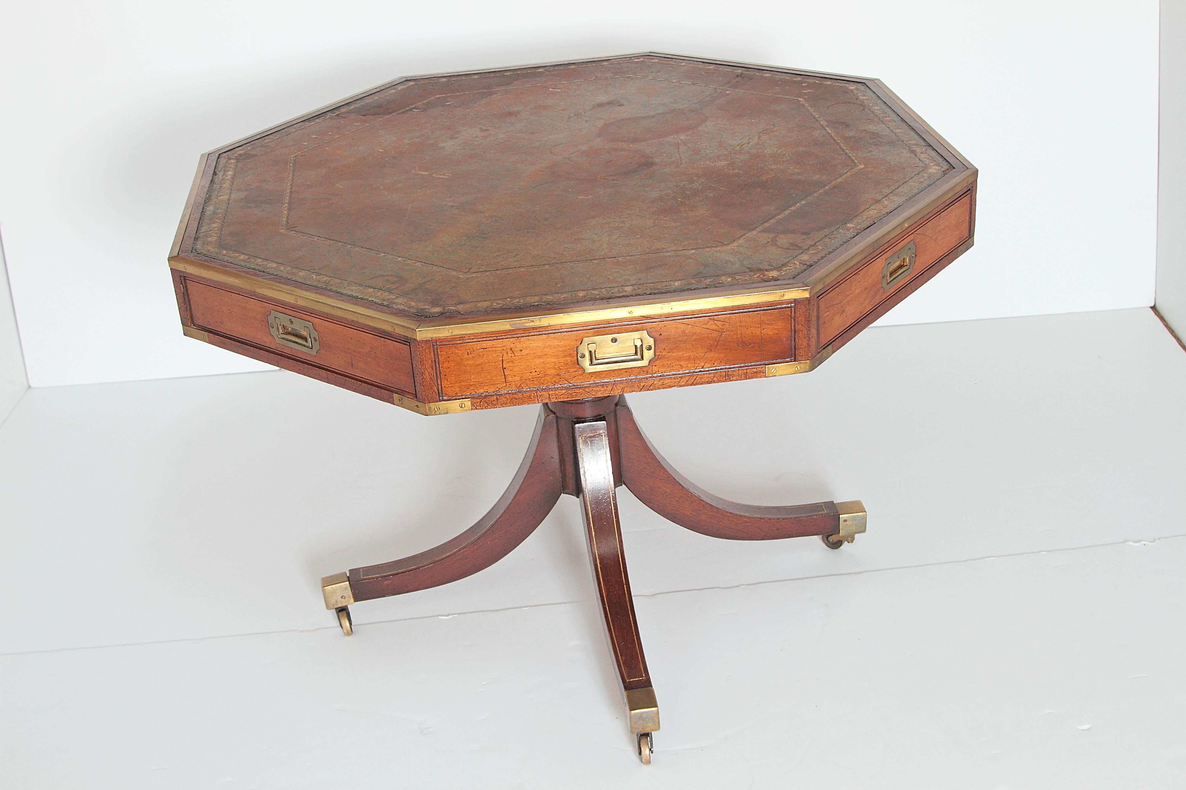 A handsome Regency mahogany drum table, octagonal not round, with distressed / 