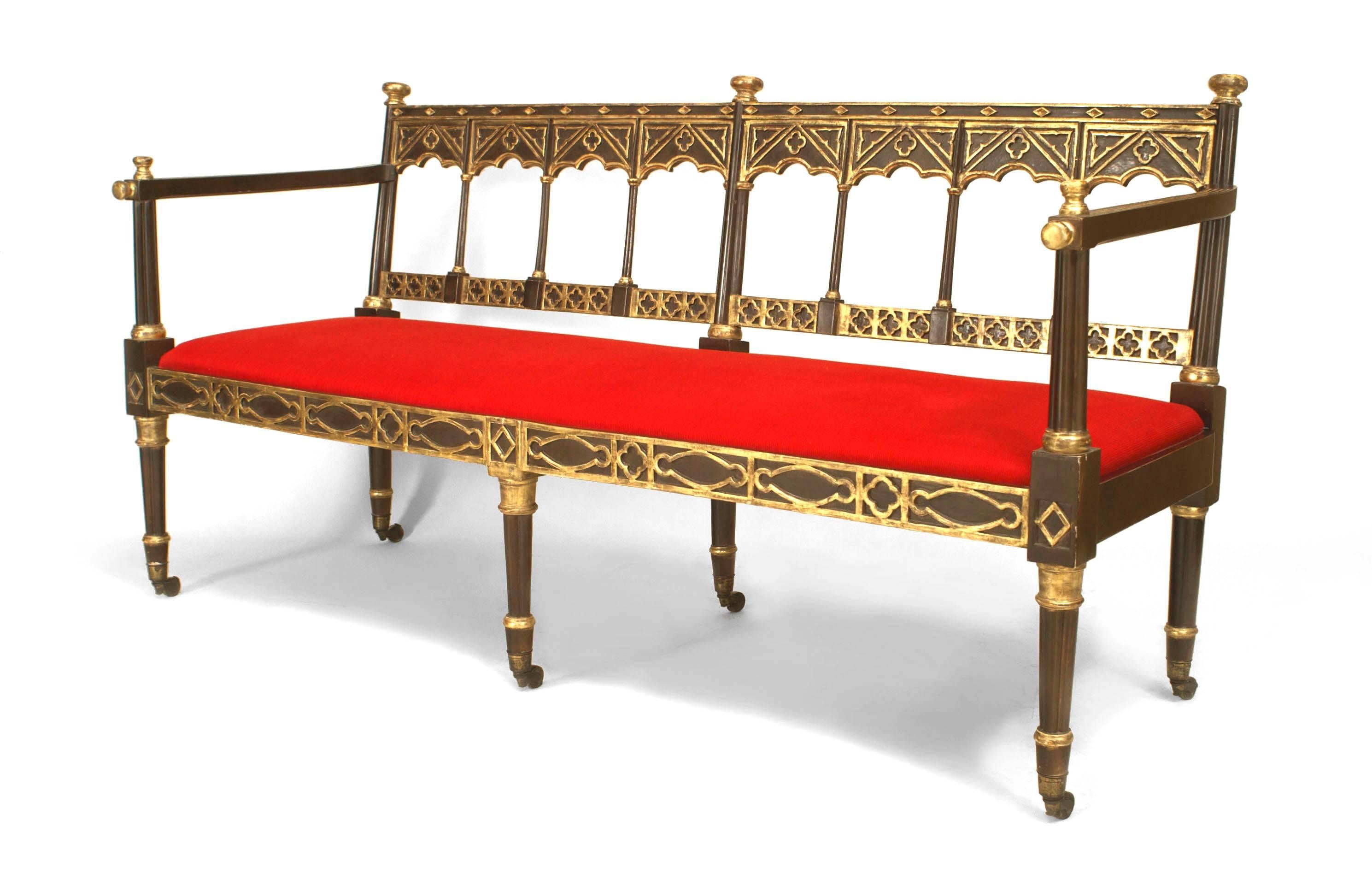 English Regency ebonized settee with painted and gilt trim and pierced back with lattice design with square arms and tapered legs with an inset upholstered seat
