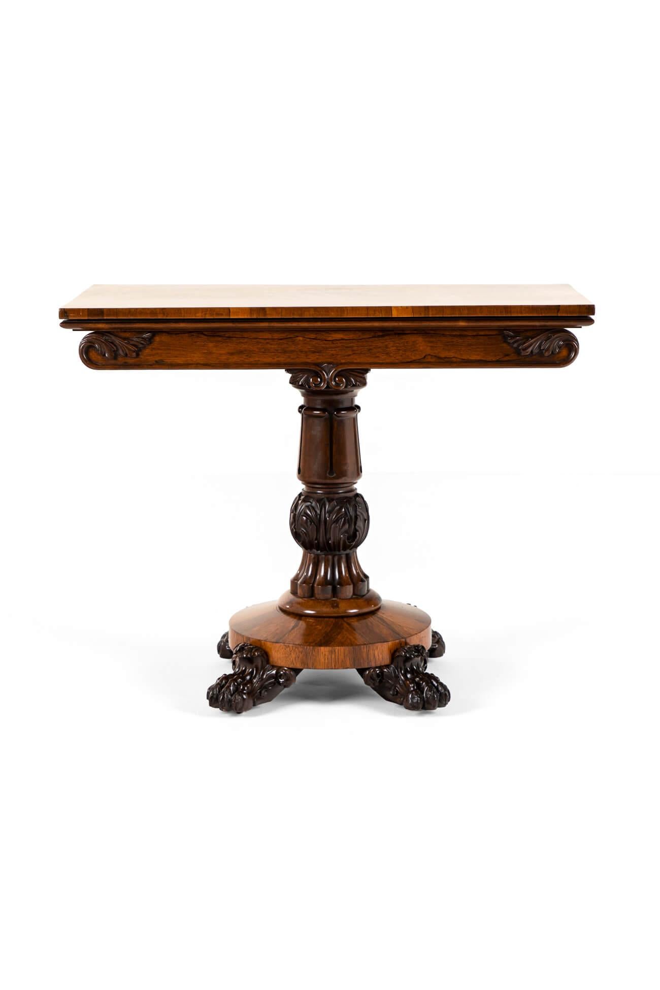 An early 19th century rosewood fold over table. The top of the table slides over on an offset pivot which reveals a generous storage compartment beneath. Once folded over the generous top doubles the size of the surface displaying a truly