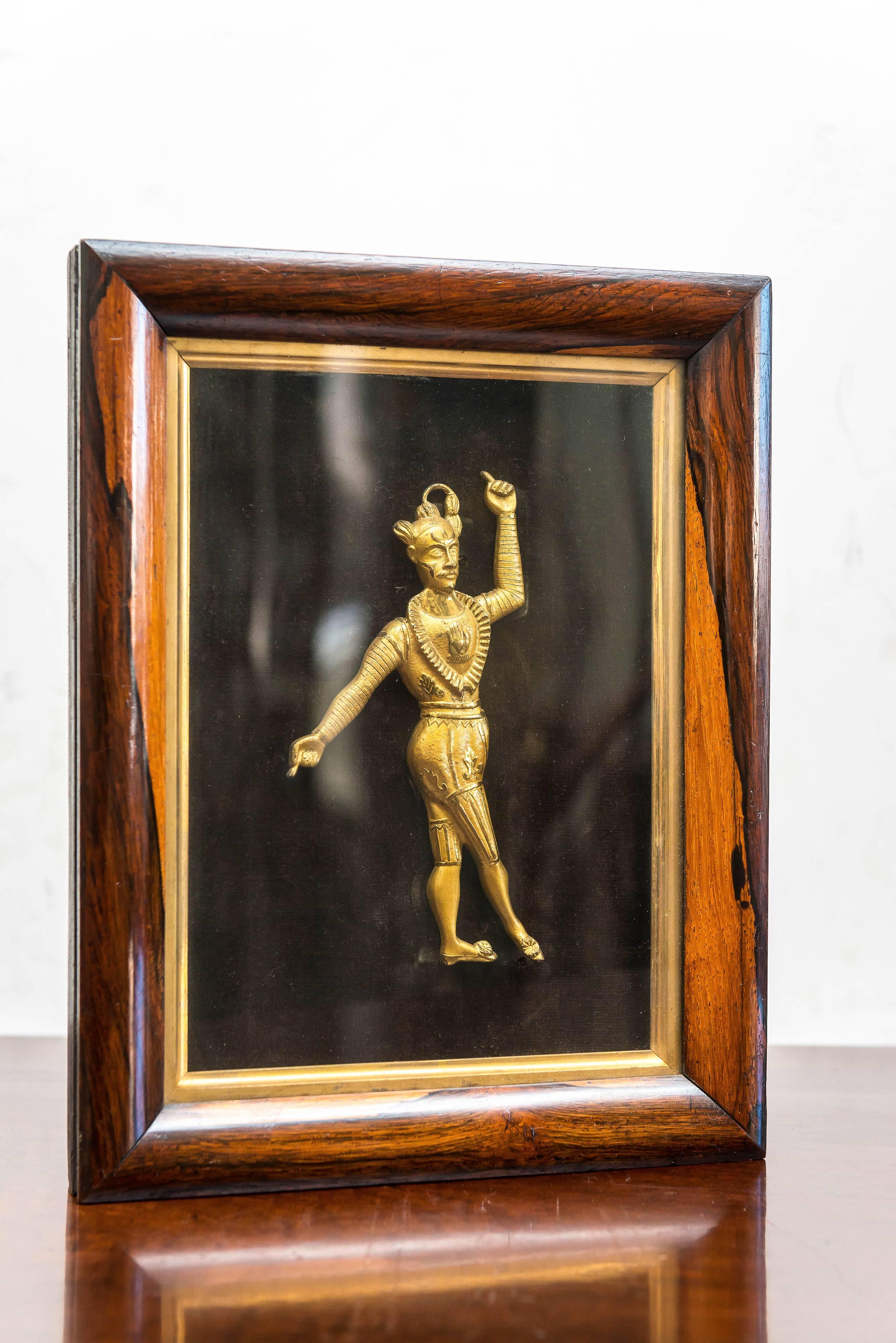 English Regency framed, fine gilt, repousse, copper figure of an exotic actor. Circa 1820. 
In the manner of a carriage decoration. Finely chiseled repousse form bearing telling details of a performance.
A somewhat Shakespearian figure posed on