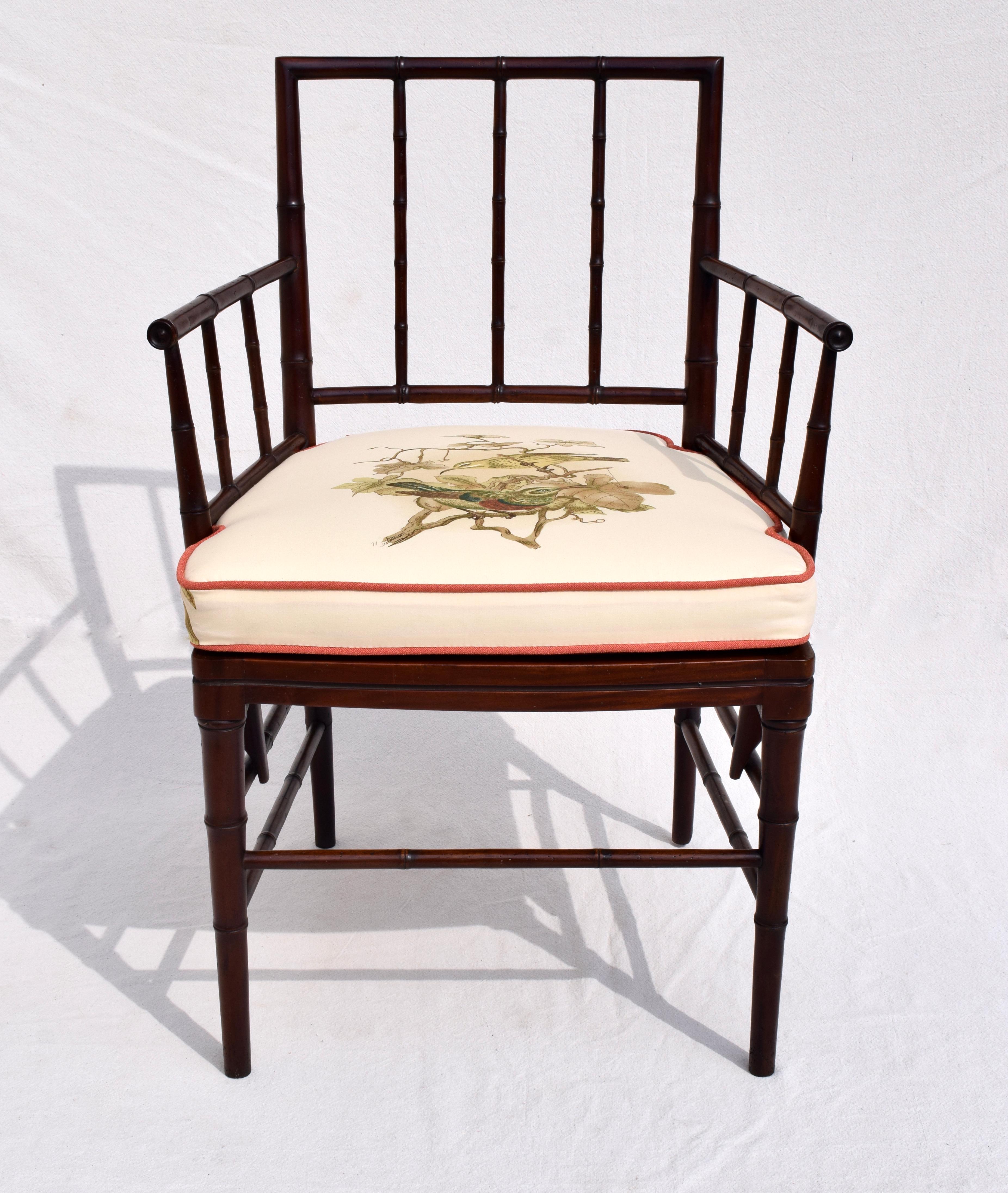 An exceptional English Regency style French caned faux bamboo armchair enhanced with custom American song birds notched cushion. Measures: Seat 18