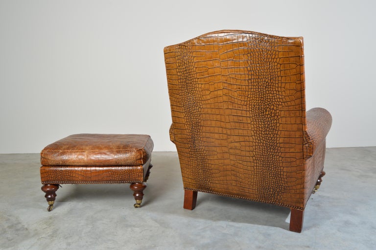English Regency brown leather gator embossed lounge chair and ottoman by Pearson.
Beautiful leather that has been well maintained and treated. The chair features solid brass sabots with solid brass casters to its front legs and to all 4 ottoman