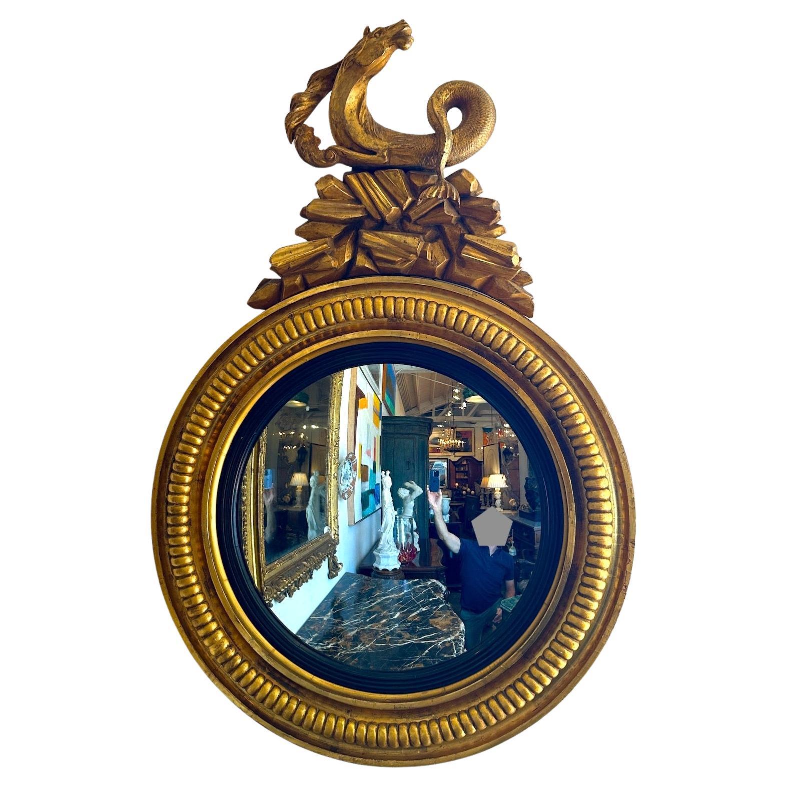Period hand-carved, English Regency, gilded and painted convex mirrors topped with hippocampus.  Sold separately.