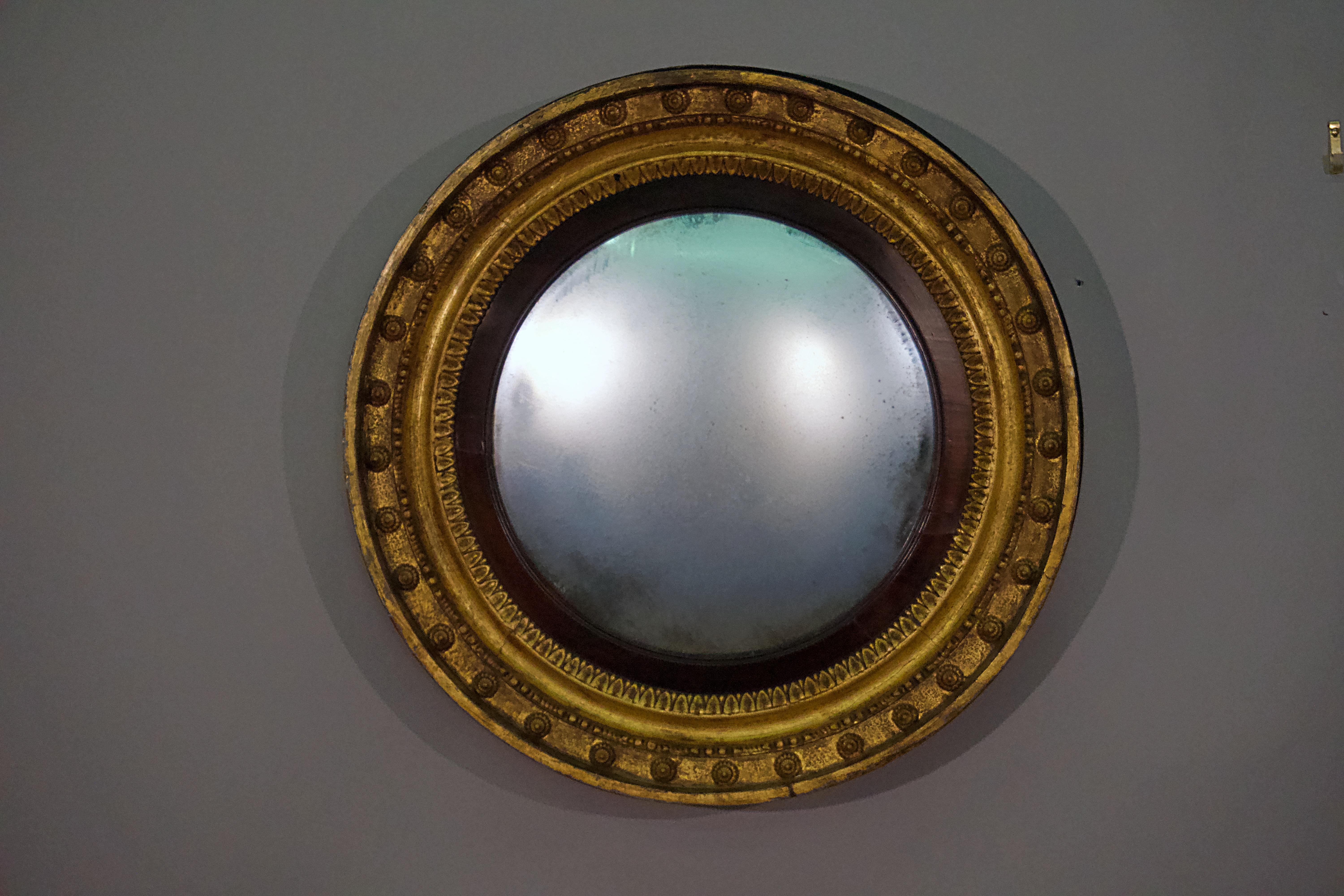 English Regency giltwood convex mirror, circa 1815.