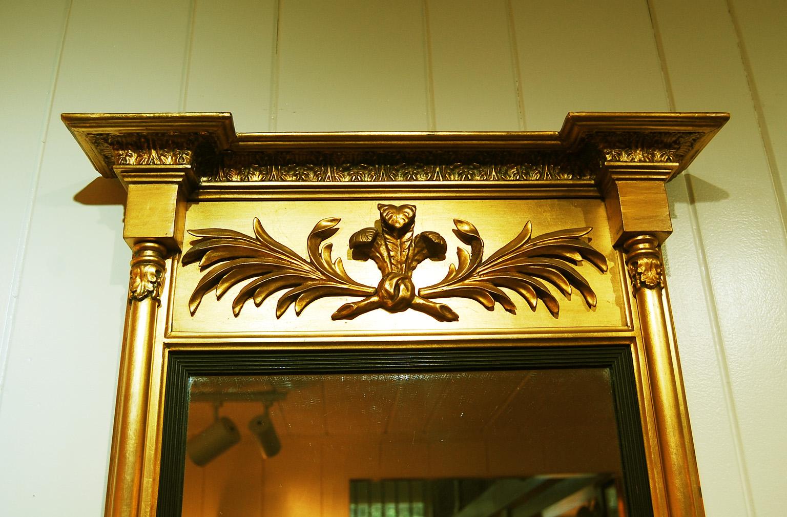

English Regency split pillar gold leaf mirror with well formed Prince of Wales feathers and leaves in the frieze.  The side columns are split pillars with good detailing to the top, middle and bottom.  The cove shaped cornice is bold with leaf