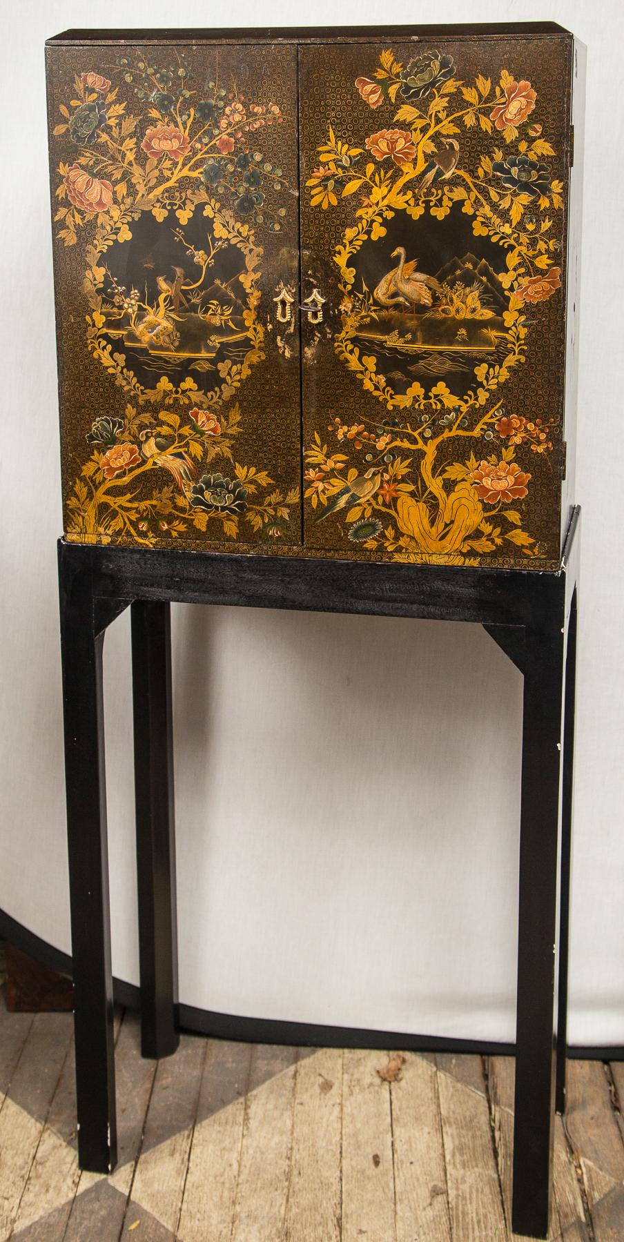 Lacquer in the Japanese style. Double doors, interior with multiple graduated drawers. On a modern Stand. Drawers increase from 1.5 to 2.5 inches in depth. There are 8 drawers behind each door for a total of 16 drawers. Probably made as a collectors