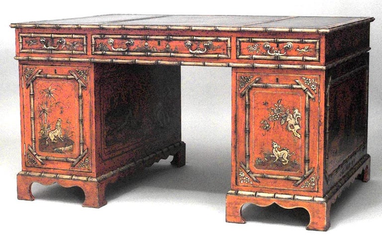 English Regency style red lacquered chinoiserie decorated knee hole partners desk with green leather 3 panel top.