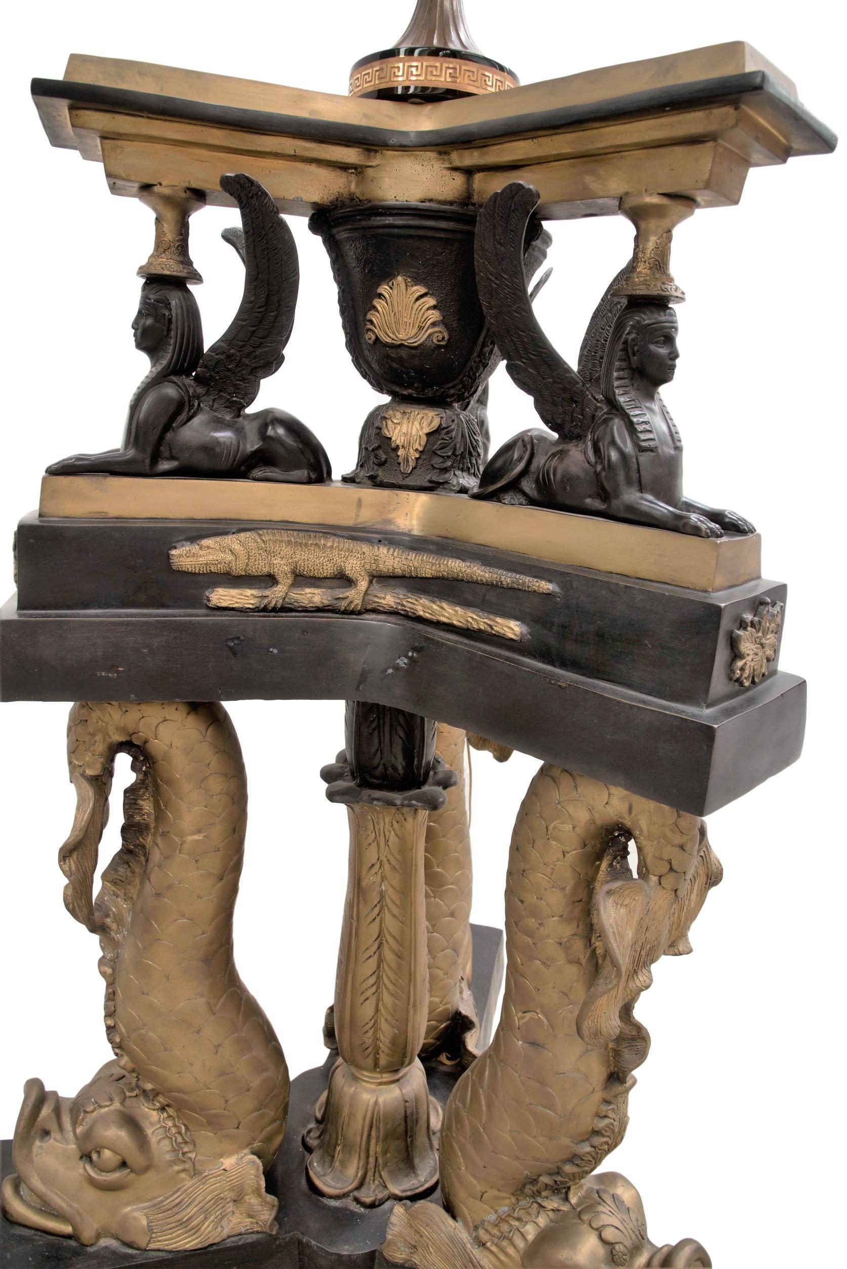 Extraordinary bronze lamp, based on the original lamp part of the famous Dolphin Suite.
A spectacular example of Regency flamboyance, this fish-adorned suite of furniture, was made in circa 1810. For the aptly named Mr. John Fish to homage Lord