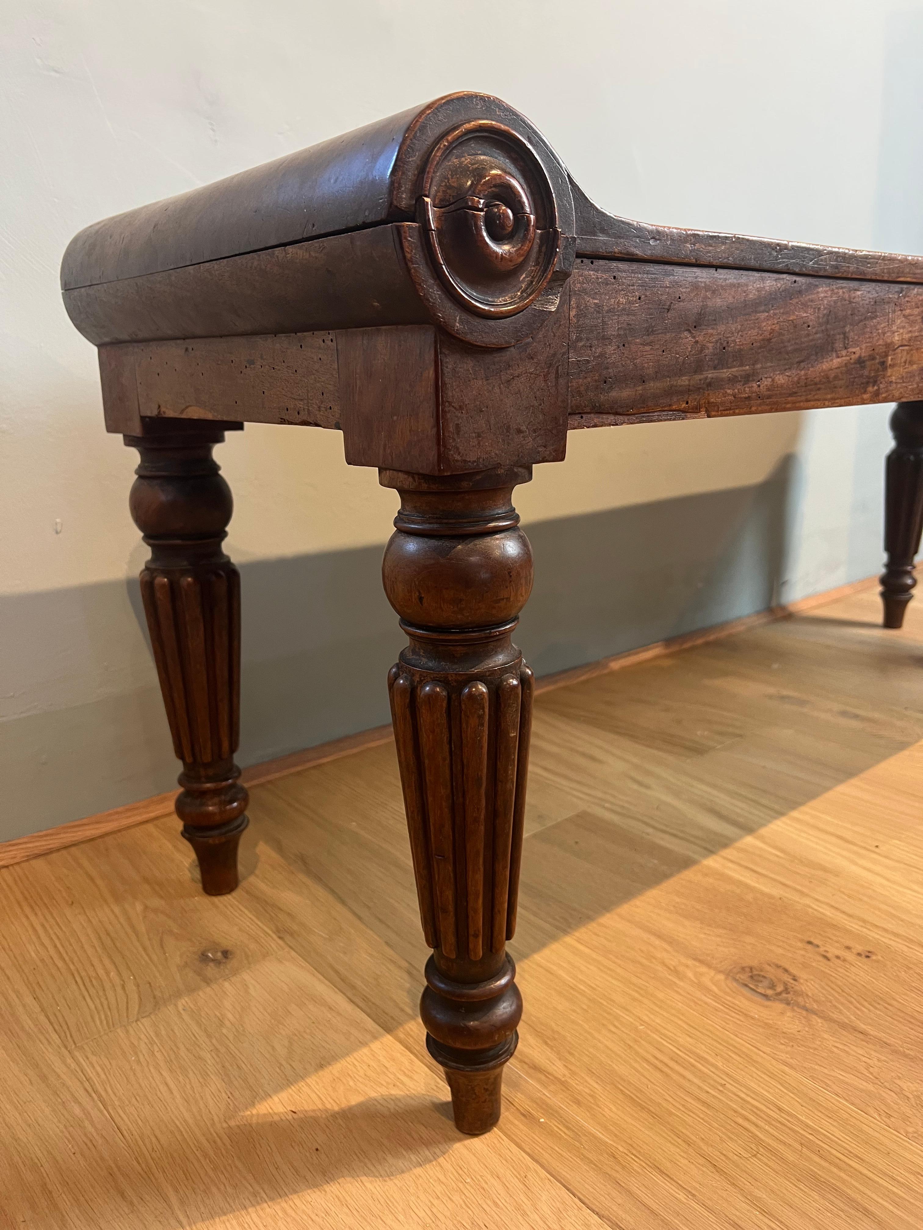 Attributed to Gillows of Lancaster, in the manner of Tatham and Marsh, this Regency hall bench/window seat is one of the best examples of English furniture of this period.
This good scale bold bench has flowing bolster ends, turned randles,