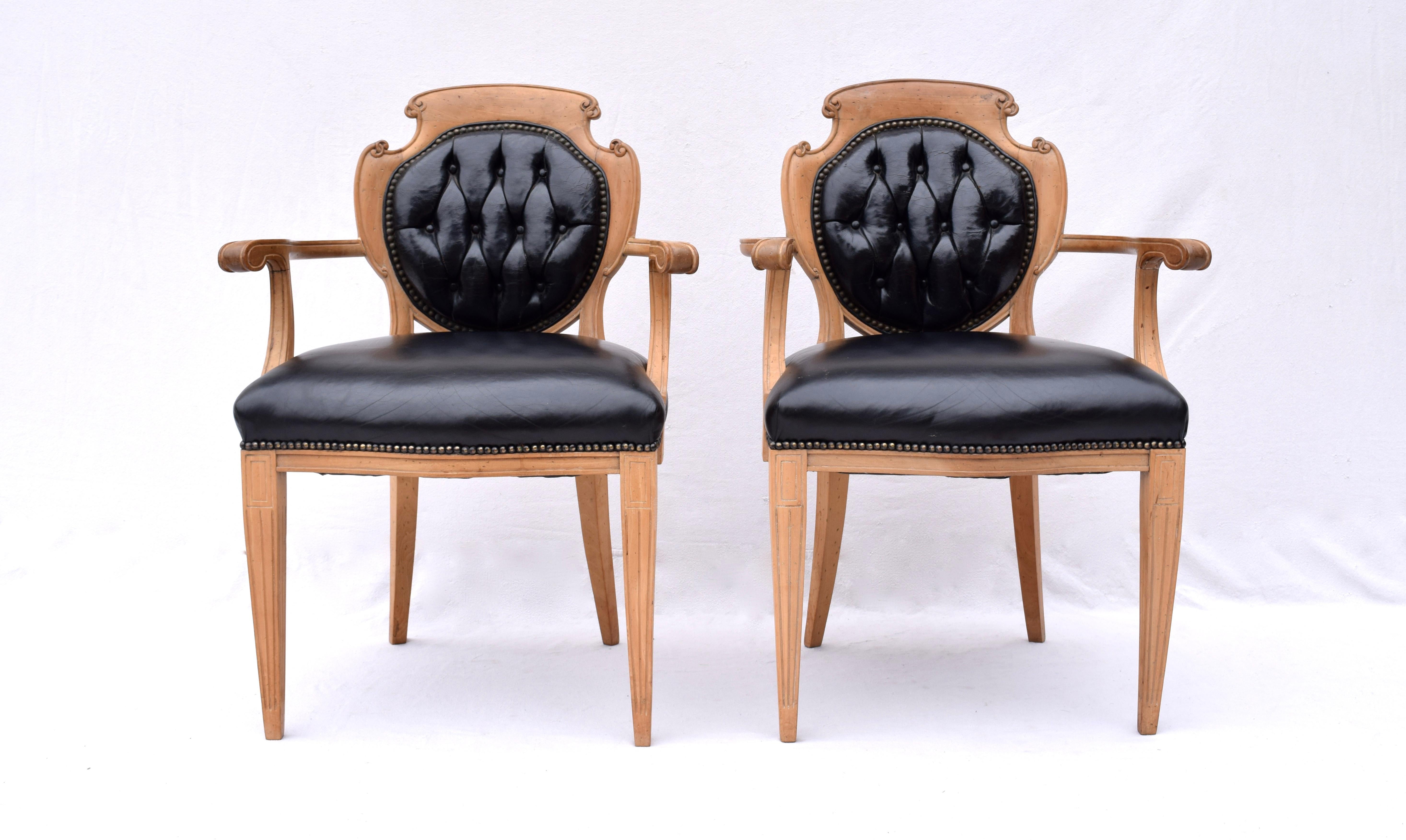 An exceptional and unique set of six English Regency style tufted leather and caned back dining chairs, circa 1950s. Excellent all original backs with replaced leather seats and brass tack nail heads reupholstered in the early 2000s.