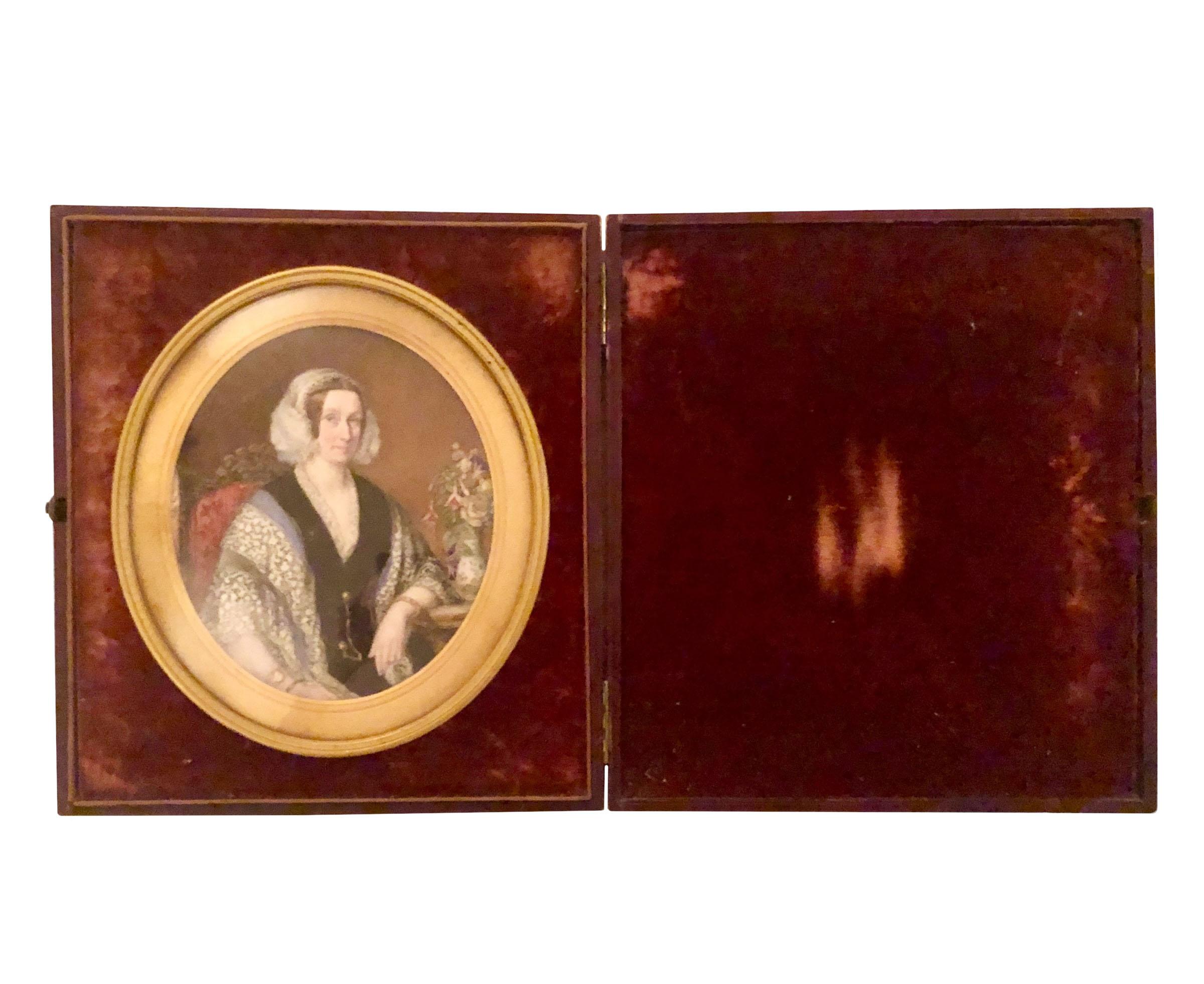 An English regency domed leather portrait box with a doré bronze border and a velvet interior. The box opens to a 19th century painting on ivory. Signed but I can’t make it out. The box has a brass latch.
