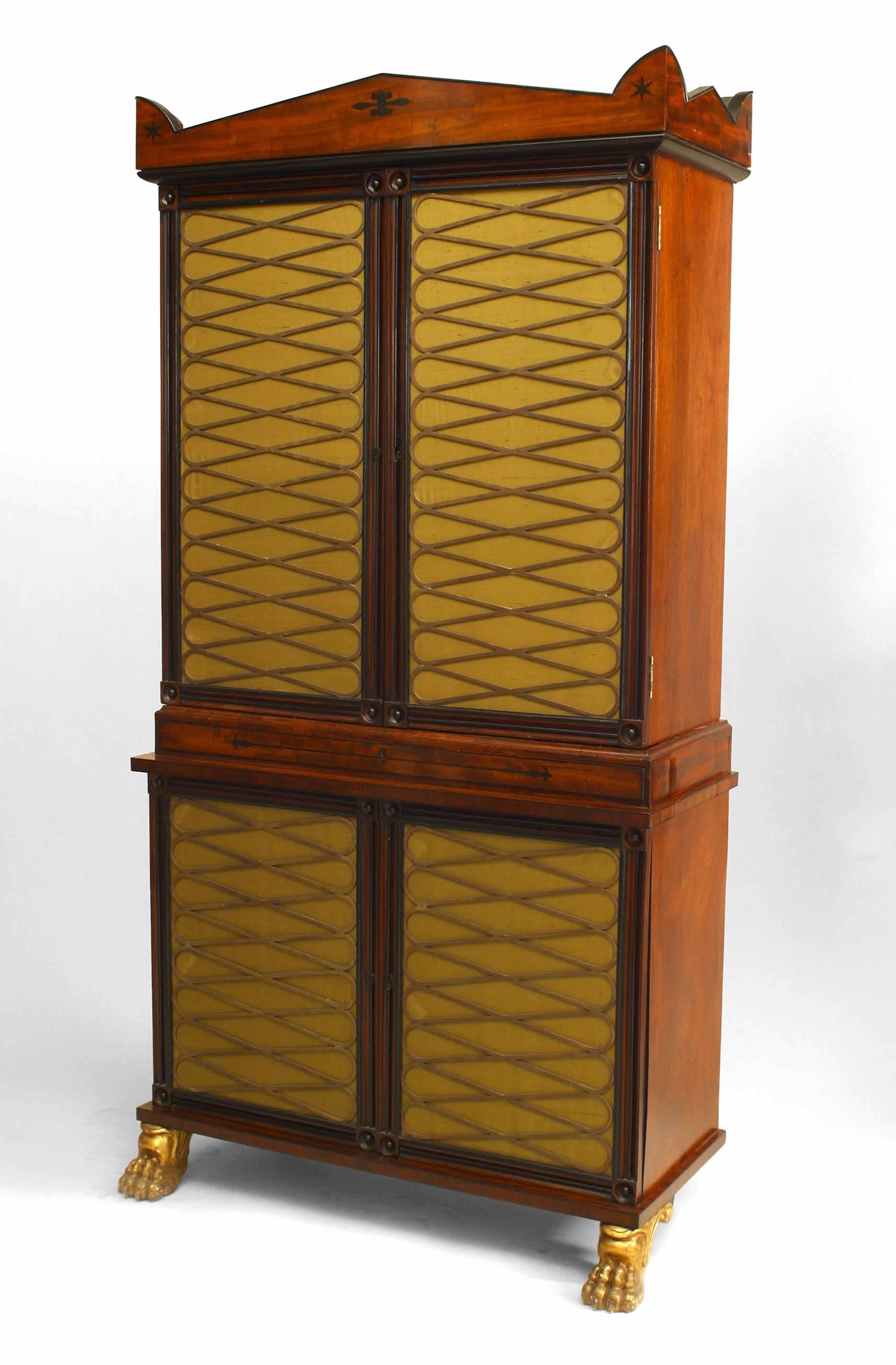 English Regency mahogany and brass trimmed four door cabinet with pull out secretary and green upholstered brass fronted doors resting on gilt wood paw feet