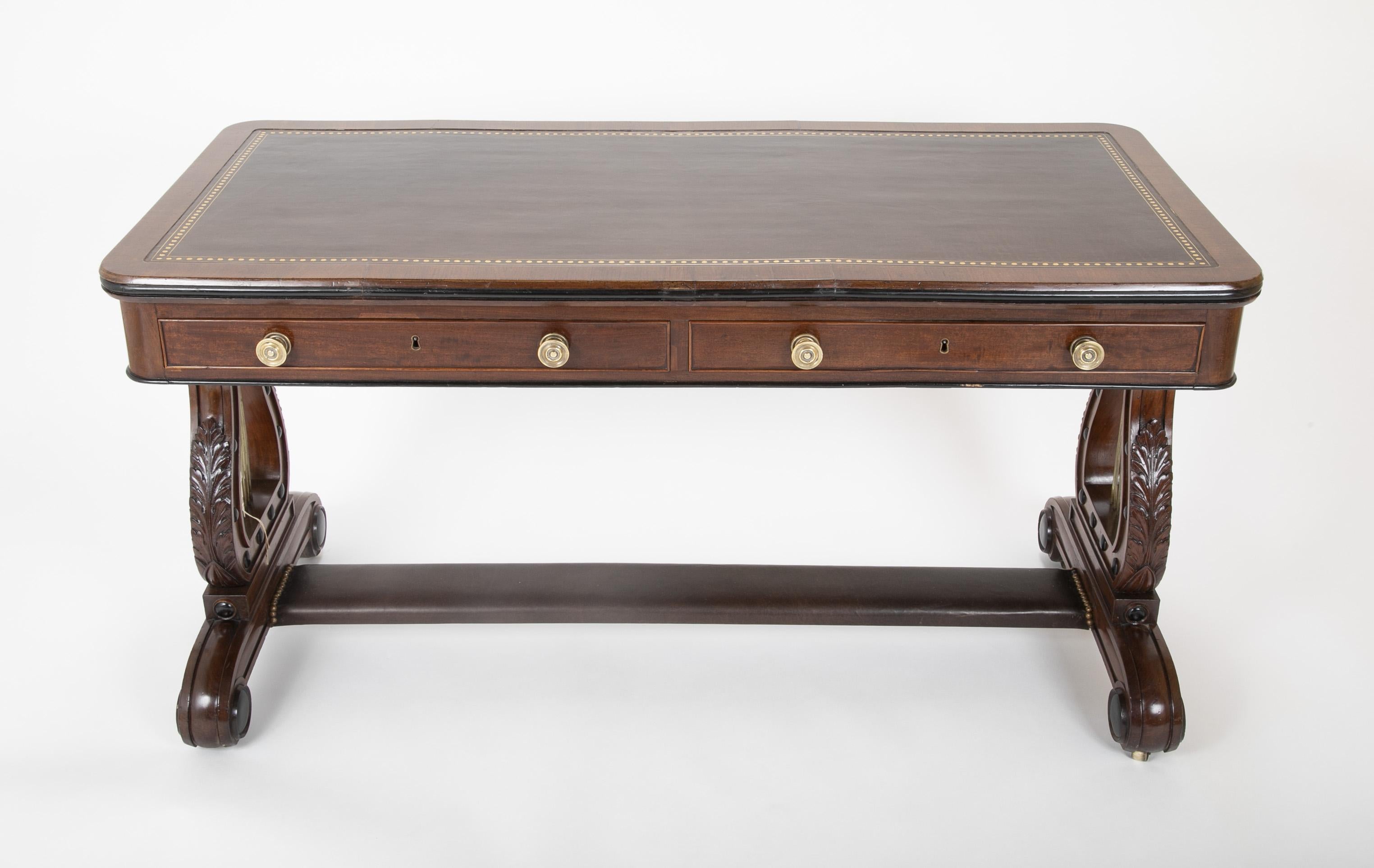 A striking English Regency mahogany sofa / writing table with lyre ends and ebonized detailing. Stretcher and desk top newly covered with leather, circa 1820.

Measures: 29.75