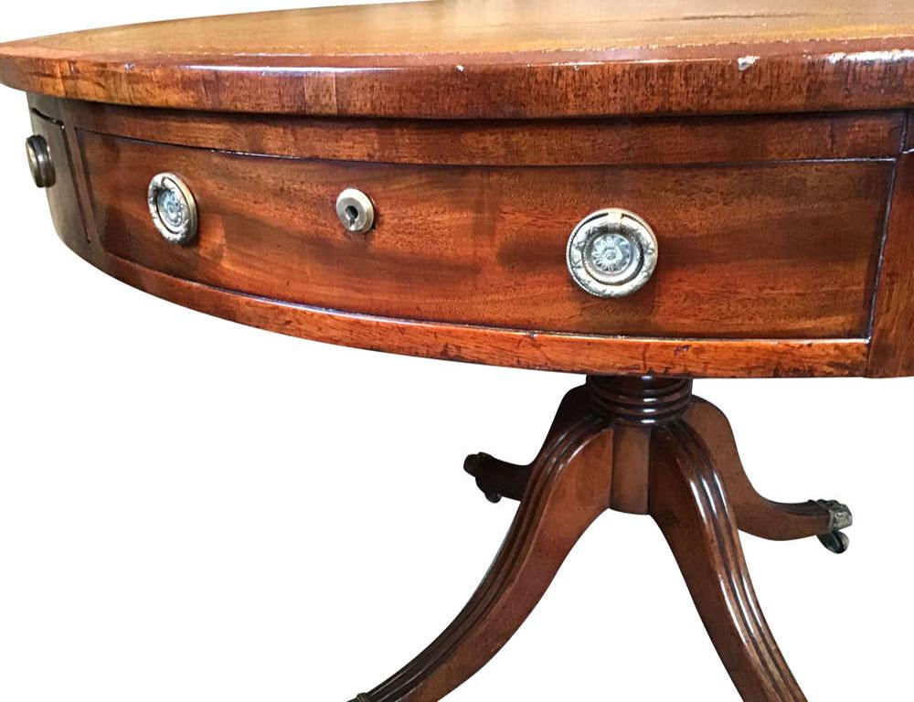 English regency mahogany and leather drum table.