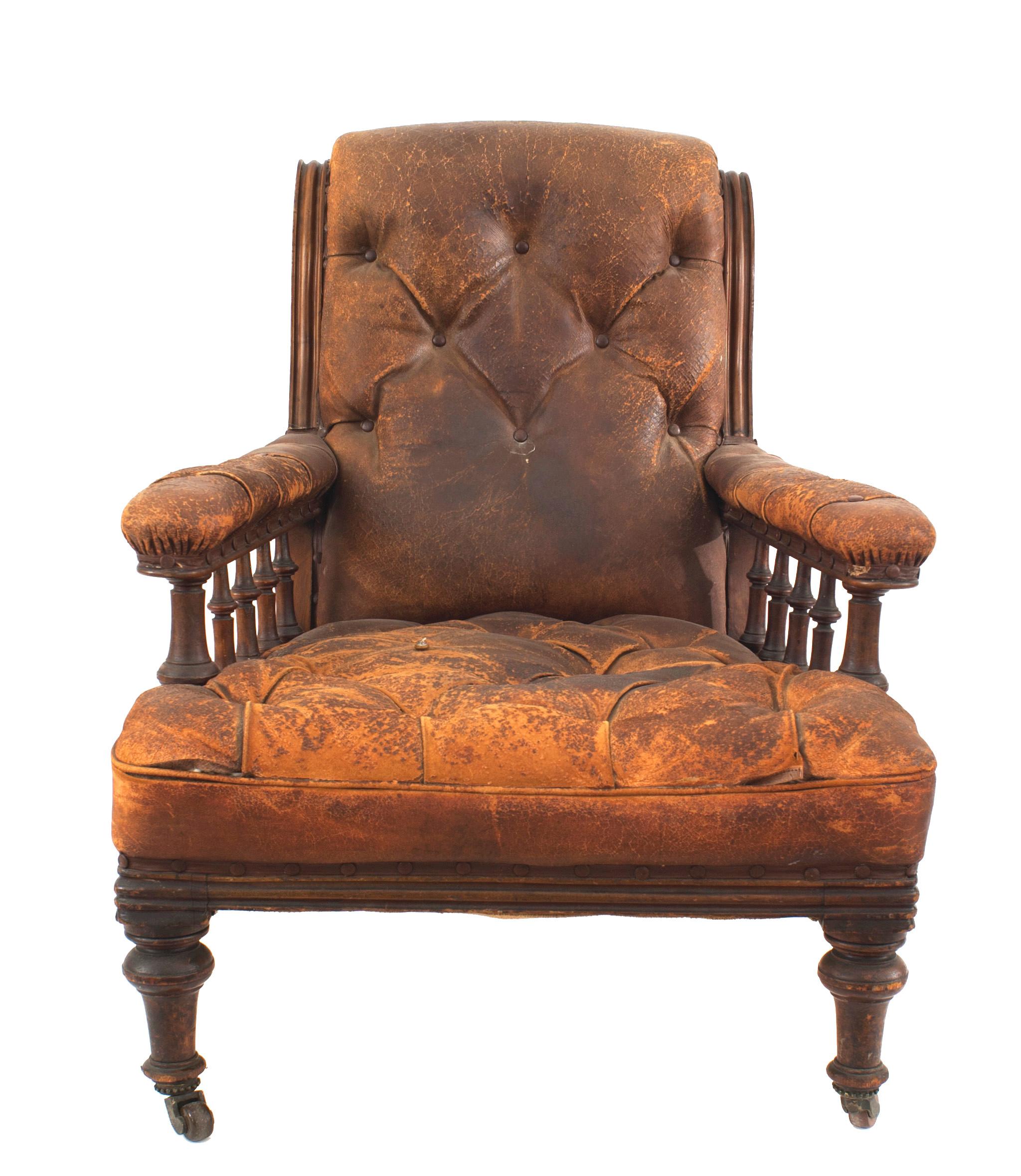 English Regency mahogany armchair with a sleigh back and spool design under both arms upholstered in a worn red tufted leather.
 