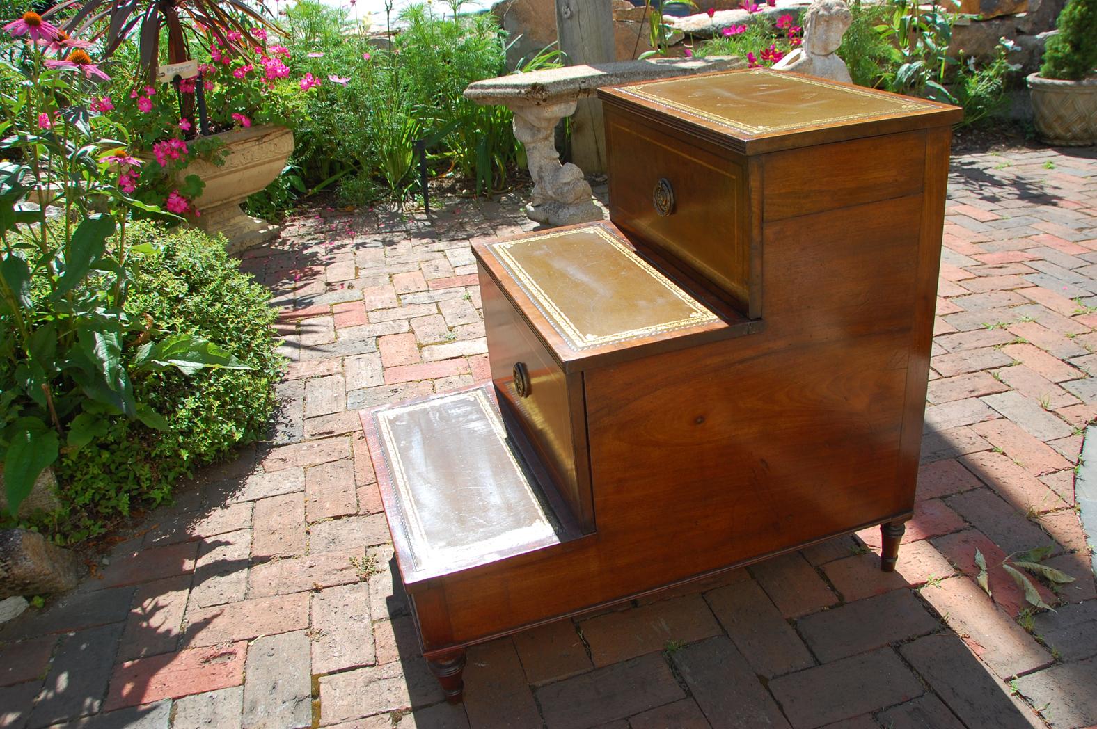 English Regency period mahogany bedstep converted commode with satinwood stringing, hand tooled and dyed leather treads, turned feet. The second step has had the commode removed and is now just a pull out drawer with a hinged top, the top step lifts