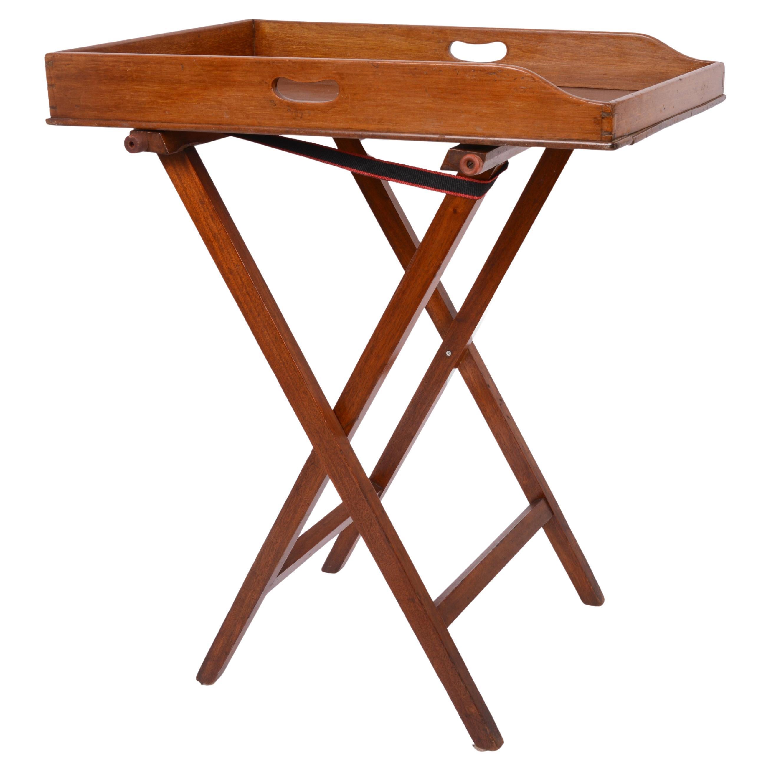 Large 19th Century Mahogany Butler's Tray is an elegant piece of furniture that combines both functionality and sophistication. Features a removable, rectangular wooden tray with raised edges, supported by folding legs. The folding legs made it easy