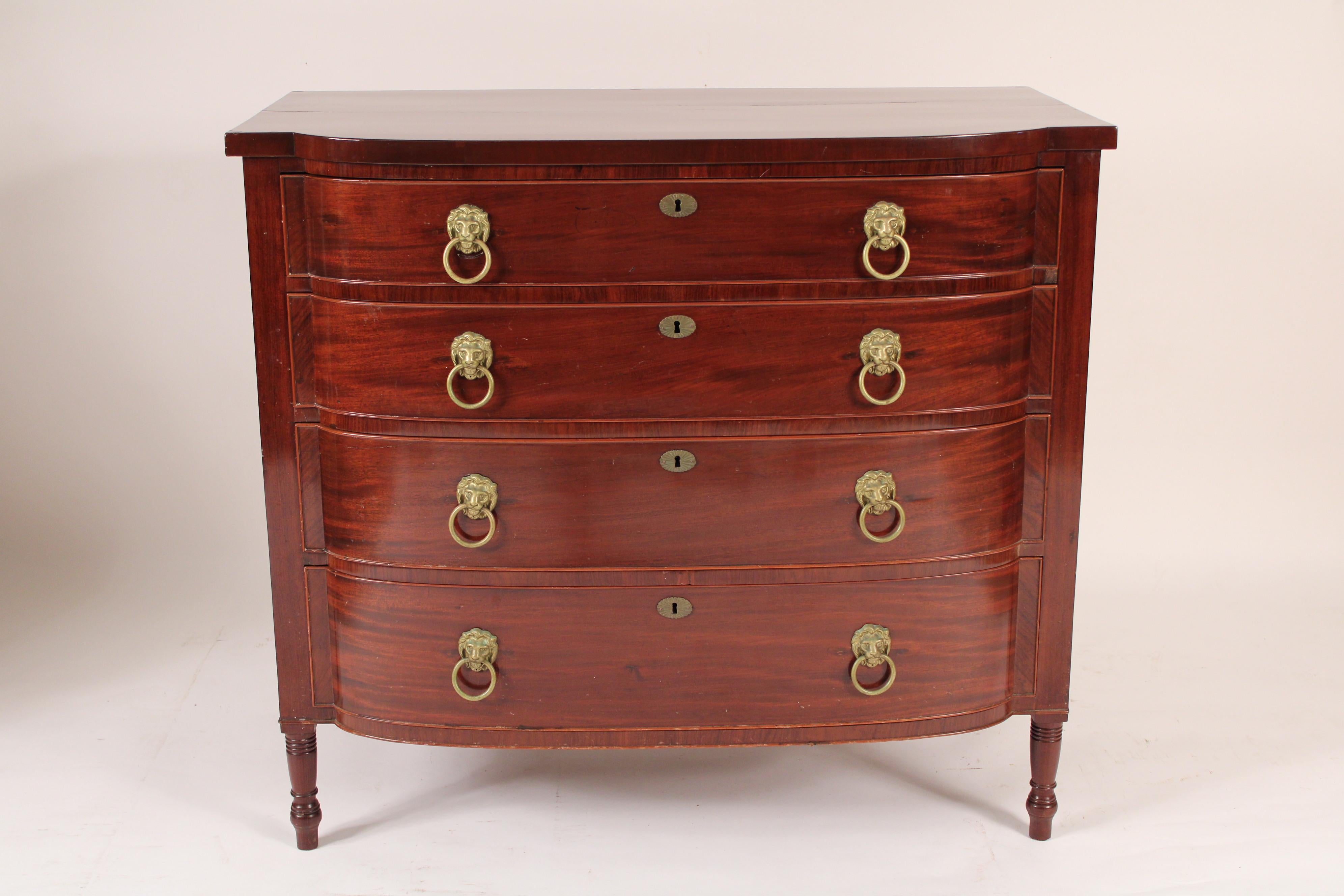 English Regency mahogany 4 drawer chest of drawers, circa 1820. With a D shaped overhanging top over 4 drawers with lion mask and ring drawer pulls resting on turned feet.
Hand dove tailed drawer construction.