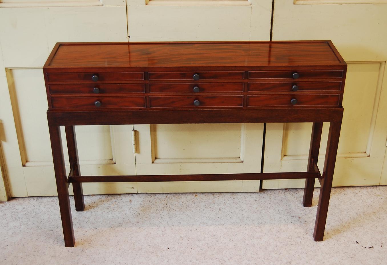 
 English Regency mahogany set of nine drawers made for a collector.  There are three vertical ranks of three drawers each, all finely dovetailed and graduated with the deepest at the bottom.  This lovely collectors box is finished all around so it