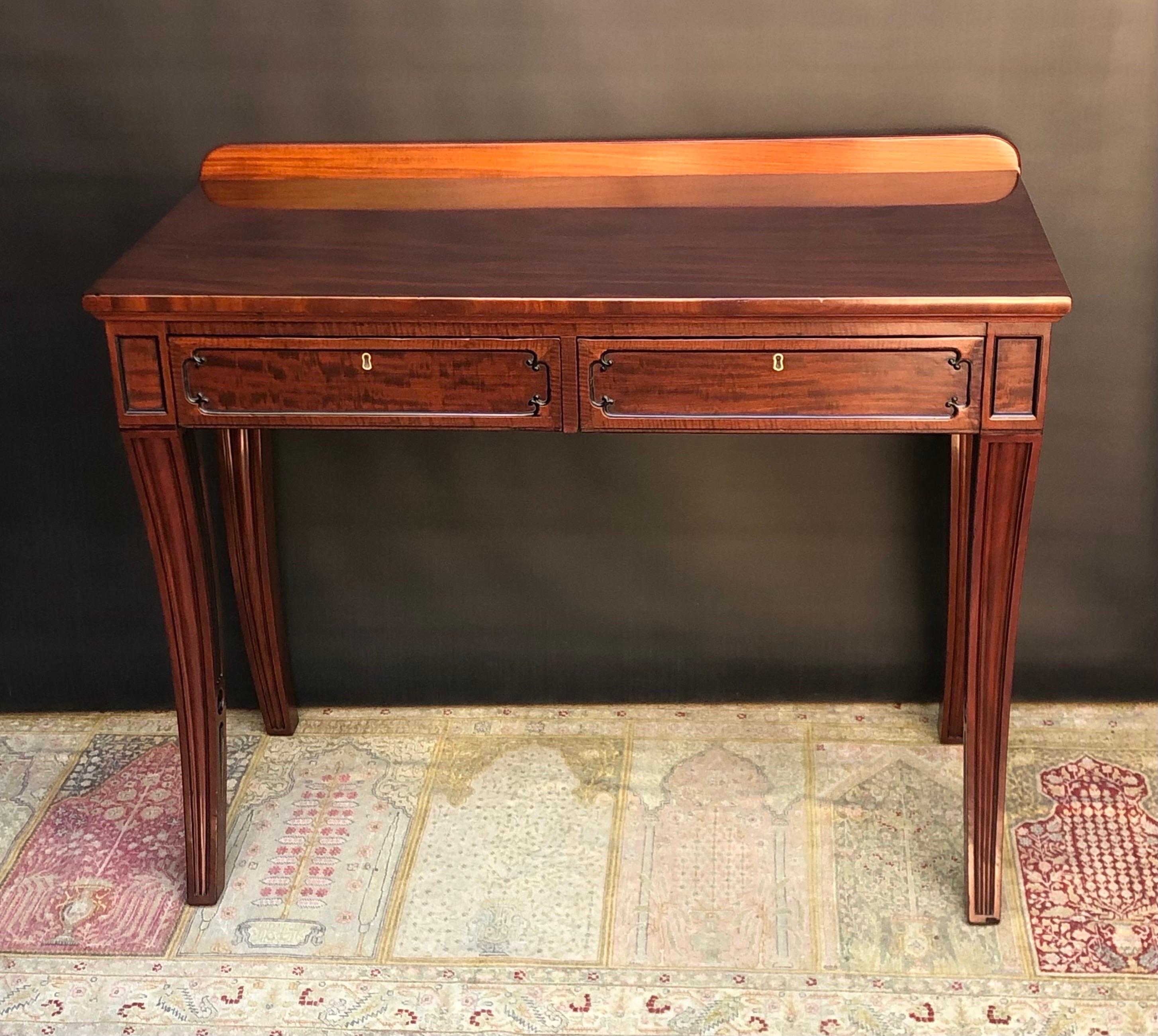 This Sophisticated English Regency Saber Leg Mahogany, Ebony & Ebonized Seddon Sideboard / Console Table was made in the early Nineteenth Century in England. The Regency Saber Leg Sideboard has a beautiful figured veneered mahogany top with a