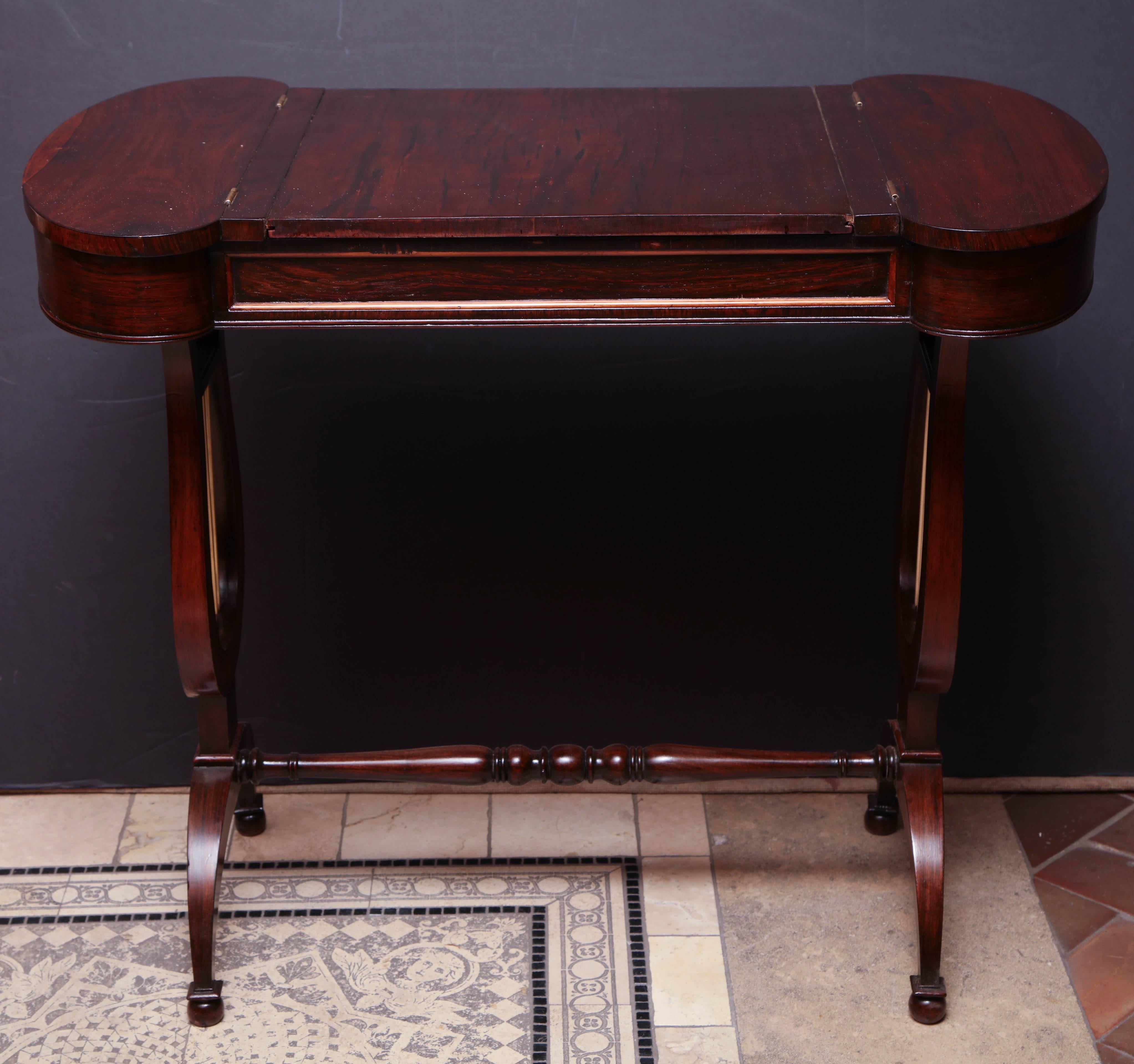Regency mahogany game table with lyre end supports, backgammon interior playing surface and a turned stretcher base.